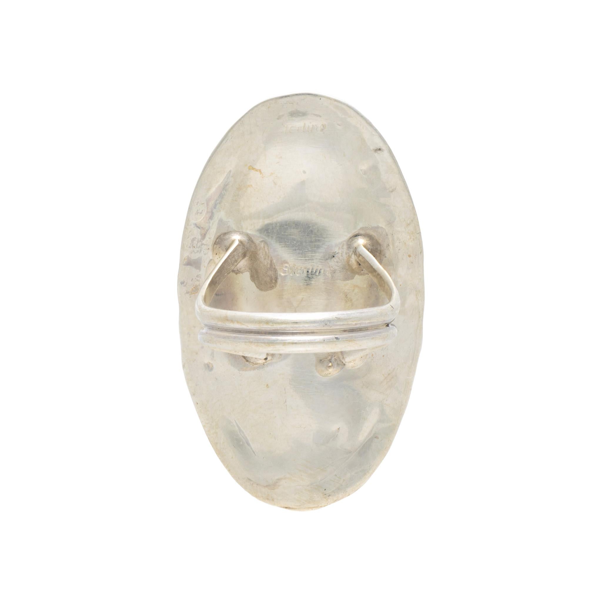 Native American Navajo Indian white buffalo turquoise ring set in sterling silver. Large center stone surrounded by classic twisted rope border having hand stamped palmettes. Maker's initials 