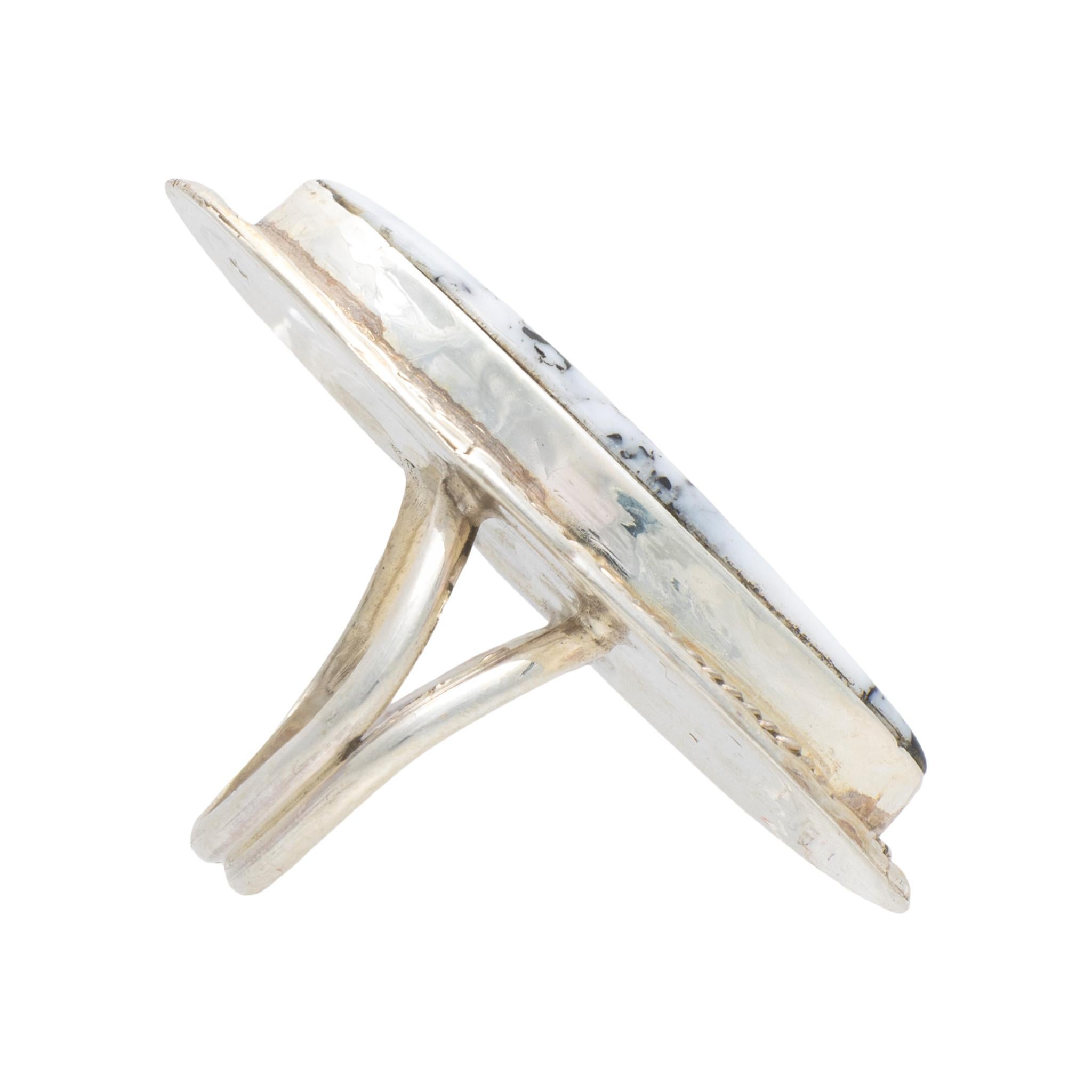 Native American Navajo Indian white buffalo turquoise ring set in sterling silver. Large center stone surrounded by classic twisted rope border having hand stamped palmettes. Maker's initials 
