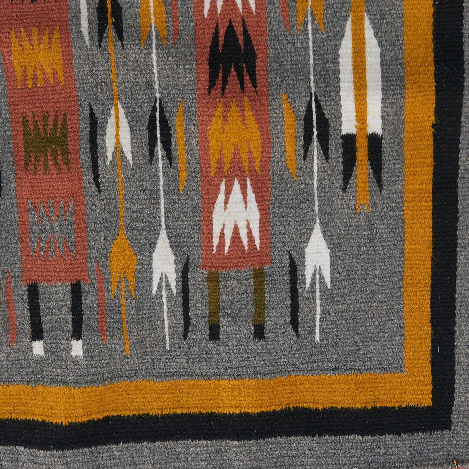 20th c., American Southwest, Navajo Yei hand-woven wool textile depicting four Yei Be Chei figures separated by corn stalks and enclosed on three sides by a Sky Guardian. The square heads of the figures indicate they are female. Male figures
