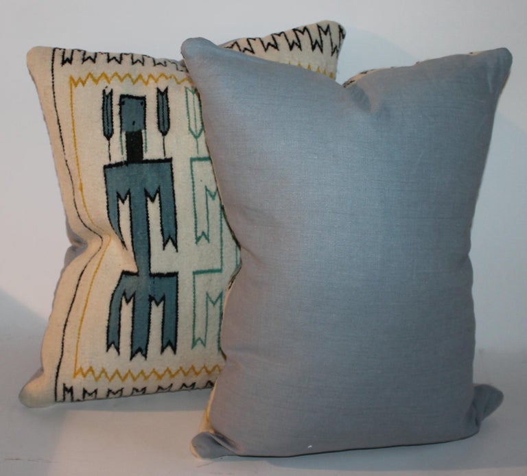 Pair of amazing Yei Indian weaving pillows with turquoise corn husk dancers. The backing is in cotton linen. Sold as a pair.