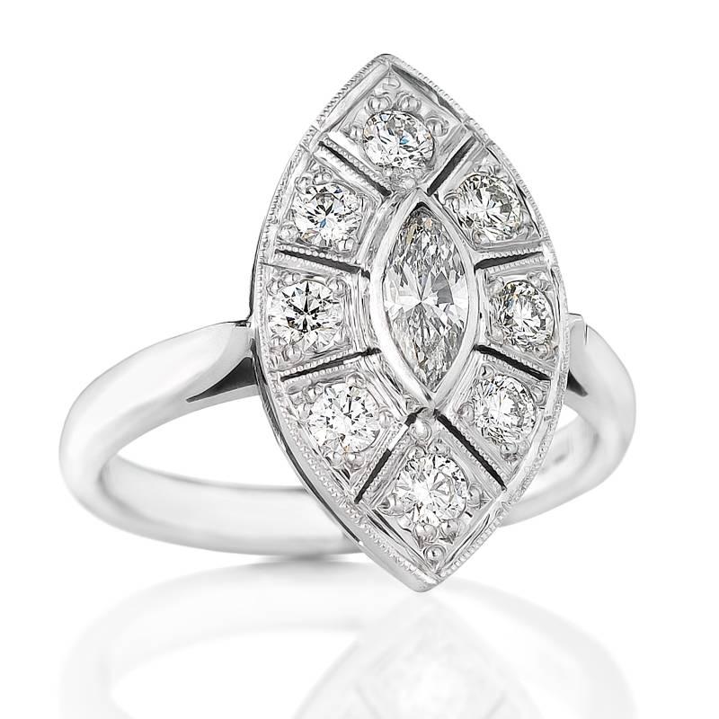 Exceptionally elegant is our Art Deco style navette shaped ring, centered with a bright 0.32ct marquise cut diamond and border of 8 round brilliant cut diamonds. Designed and handmade in-house by Imp Jewellery, the overall setting tip to tip is