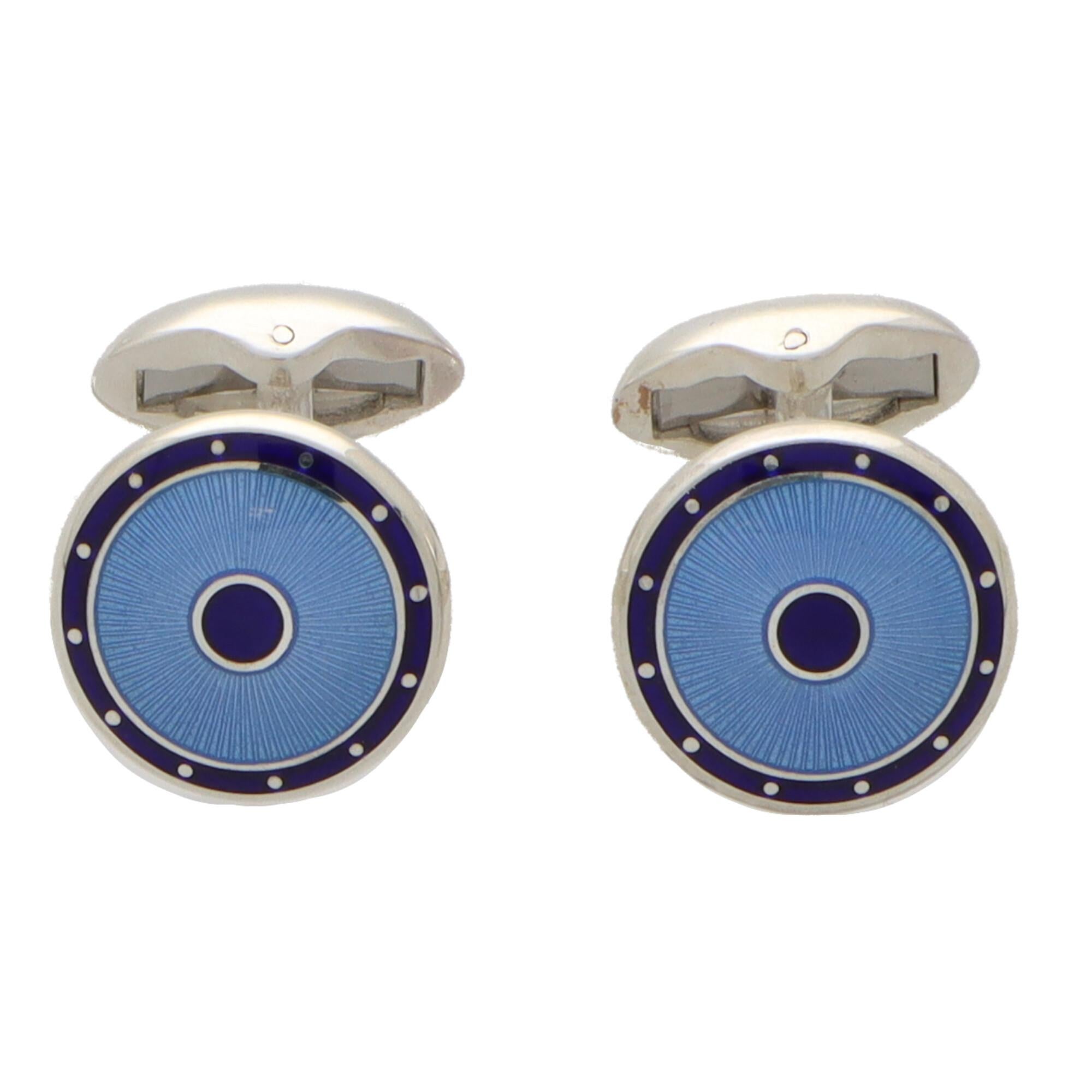 An extremely stylish pair of navy and light blue rounded shield swivel back cufflinks made in British sterling silver.

Each cufflink is composed of two rounded shield faces set centrally with a navy-blue circle and bordered blue light textured