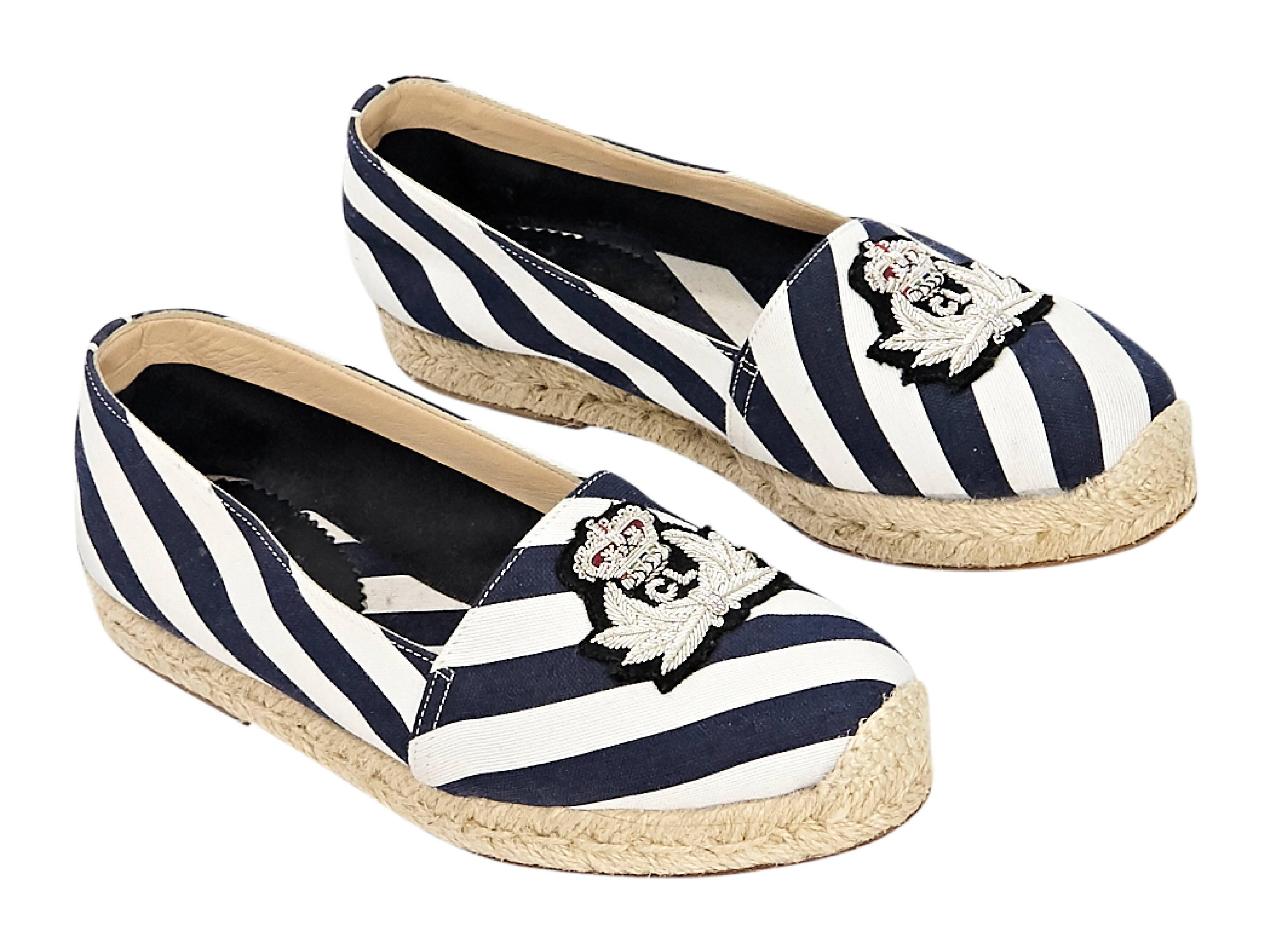 Product details:  Navy blue and white striped flat espadrilles by Christian Louboutin.  Patch accents vamp.  Round toe.  Braided jute trim.  Slip-on style. 
Condition: Pre-owned. Very good. 
Est. Retail $ 585.00