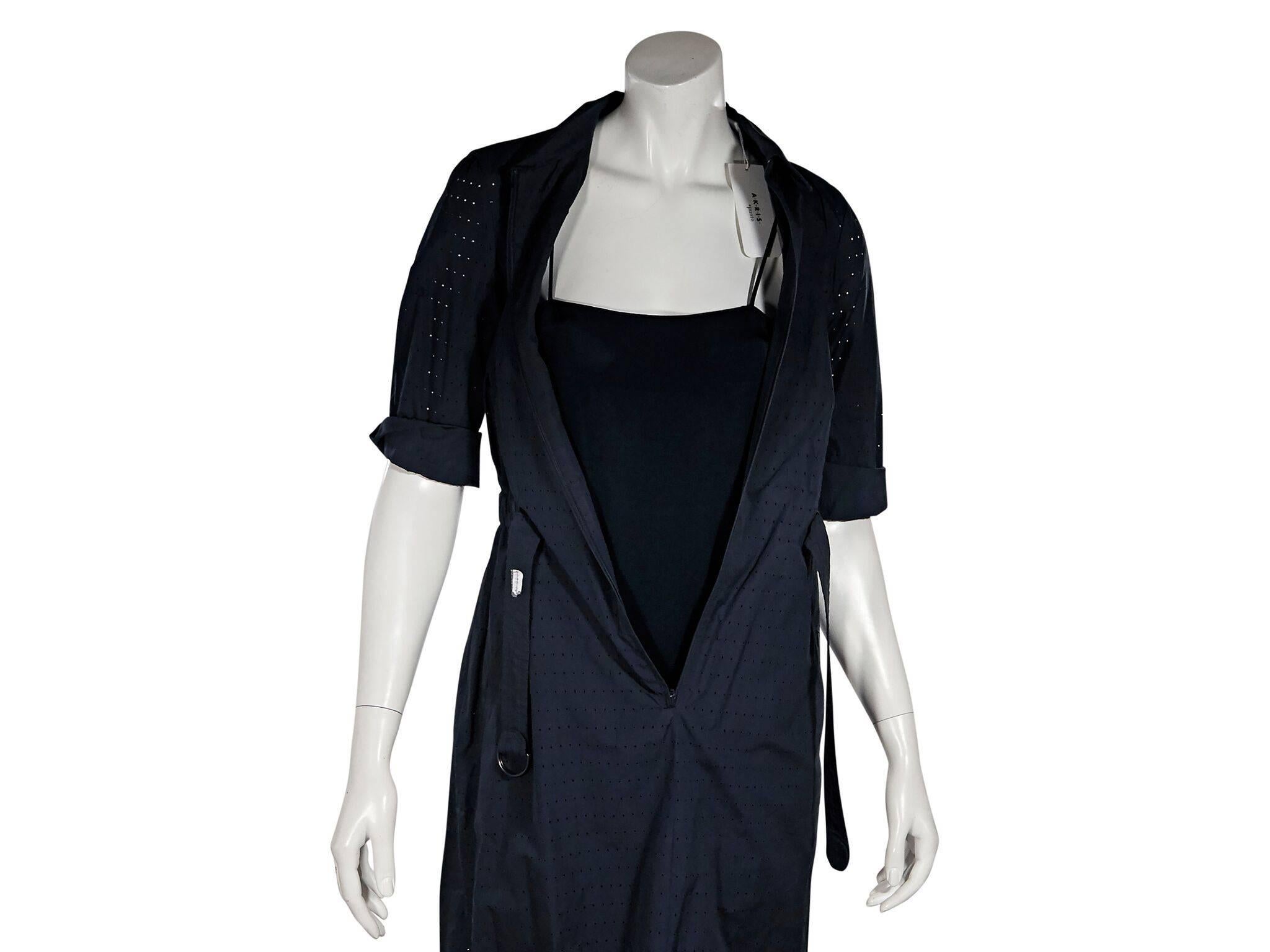 Product details:  Navy blue cotton eyelet dress by Akris.  Point collar.  Elbow-length sleeves.  Concealed zip-front closure.  Adjustable belted waist.  Slip lining.  38