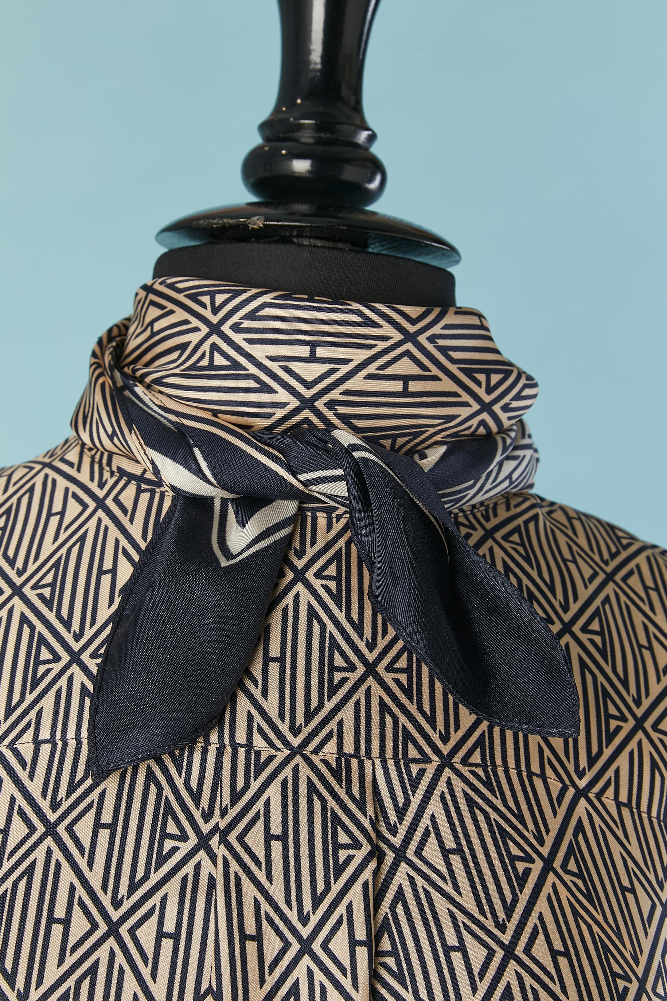 Silk branded shirt with scarf collar. One branded button closure on the top middle front and one button on each cuff. 
SIZE M 