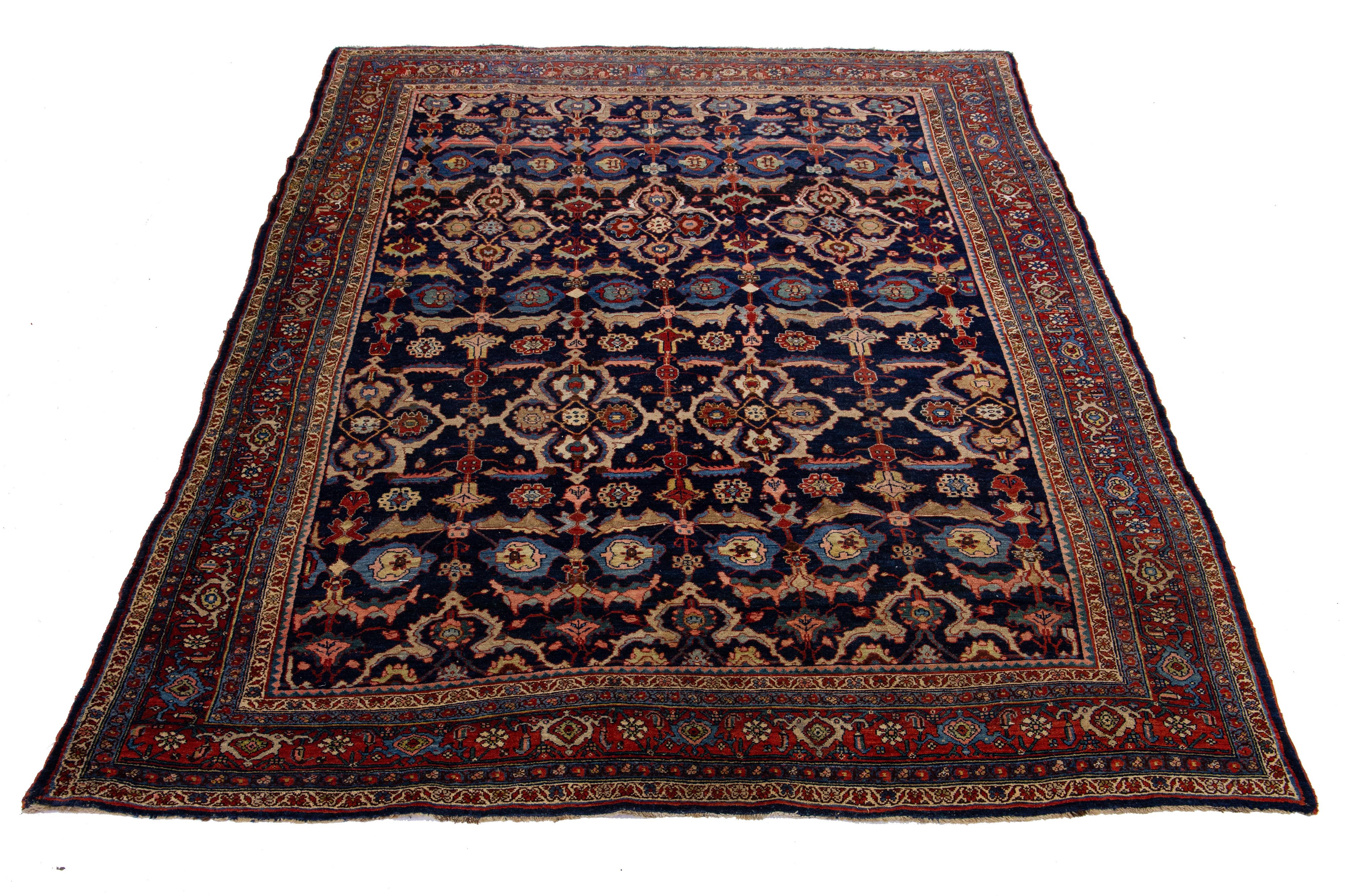 Beautiful antique Bidjar hand-knotted wool rug with a navy blue color field. This Persian rug has a red frame with multicolor accents in a gorgeous all-over traditional floral design.

This rug measures 7'9