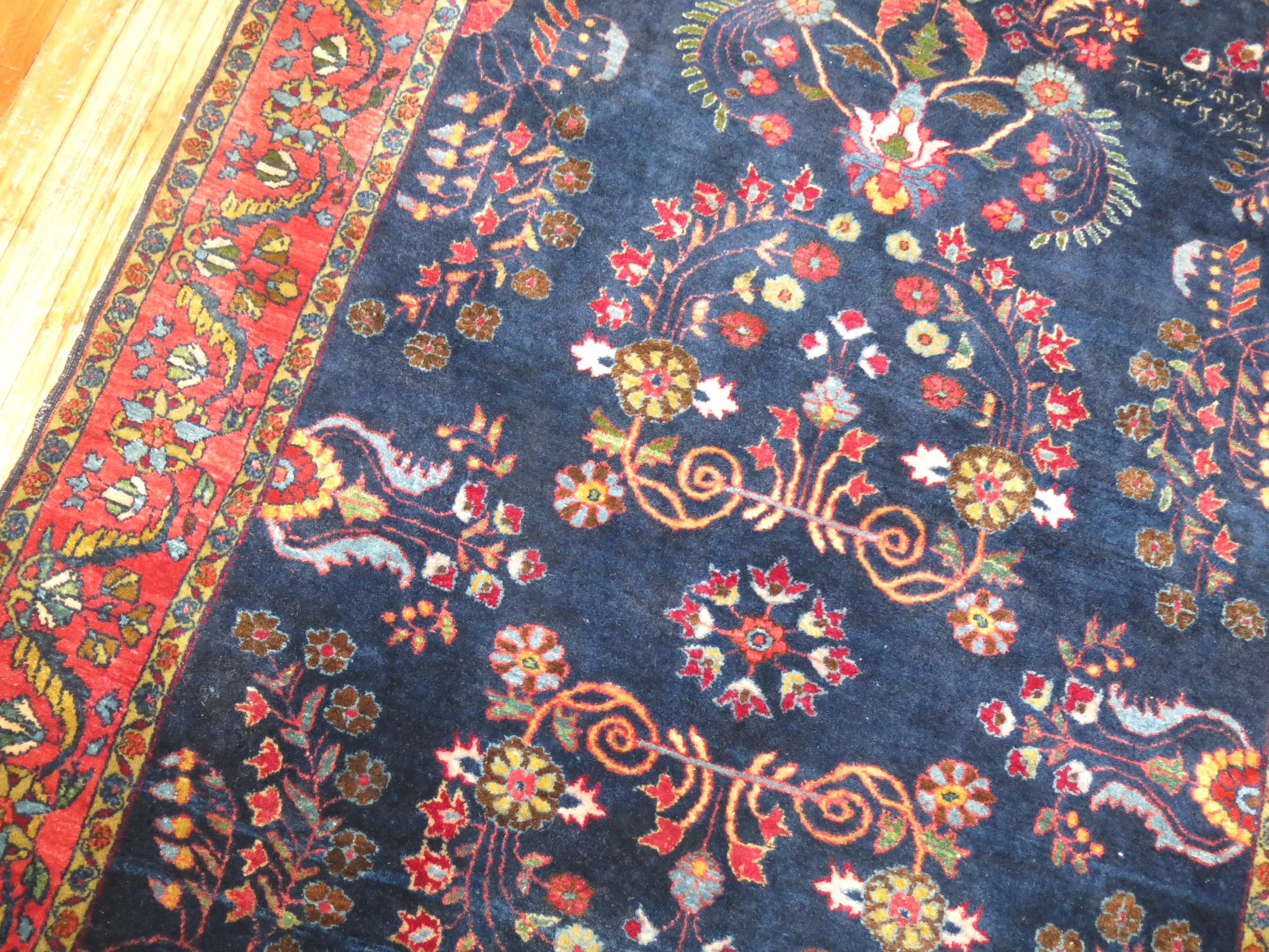 Stunning early 20th century Persian Sarouk rug.

Before the 1920s the Sarouk design was the most popular of Persian rugs worldwide. Most of them consist of deep red fields with navy borders. Rarely are they found in inverse colors like this