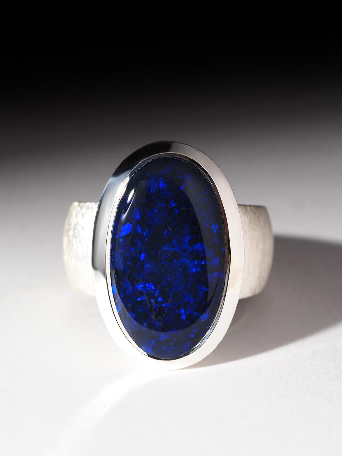 Big silver ring with natural Black Opal
weight of the Opal - 21.10 carat 
size of the ring - 9 US, diameter 19 mm, N 20, 60 circumference
ring weight - 15 grams
stone measurements - 0.47 х 0.83 in / 12 х 21 mm
Opal origin - Australia