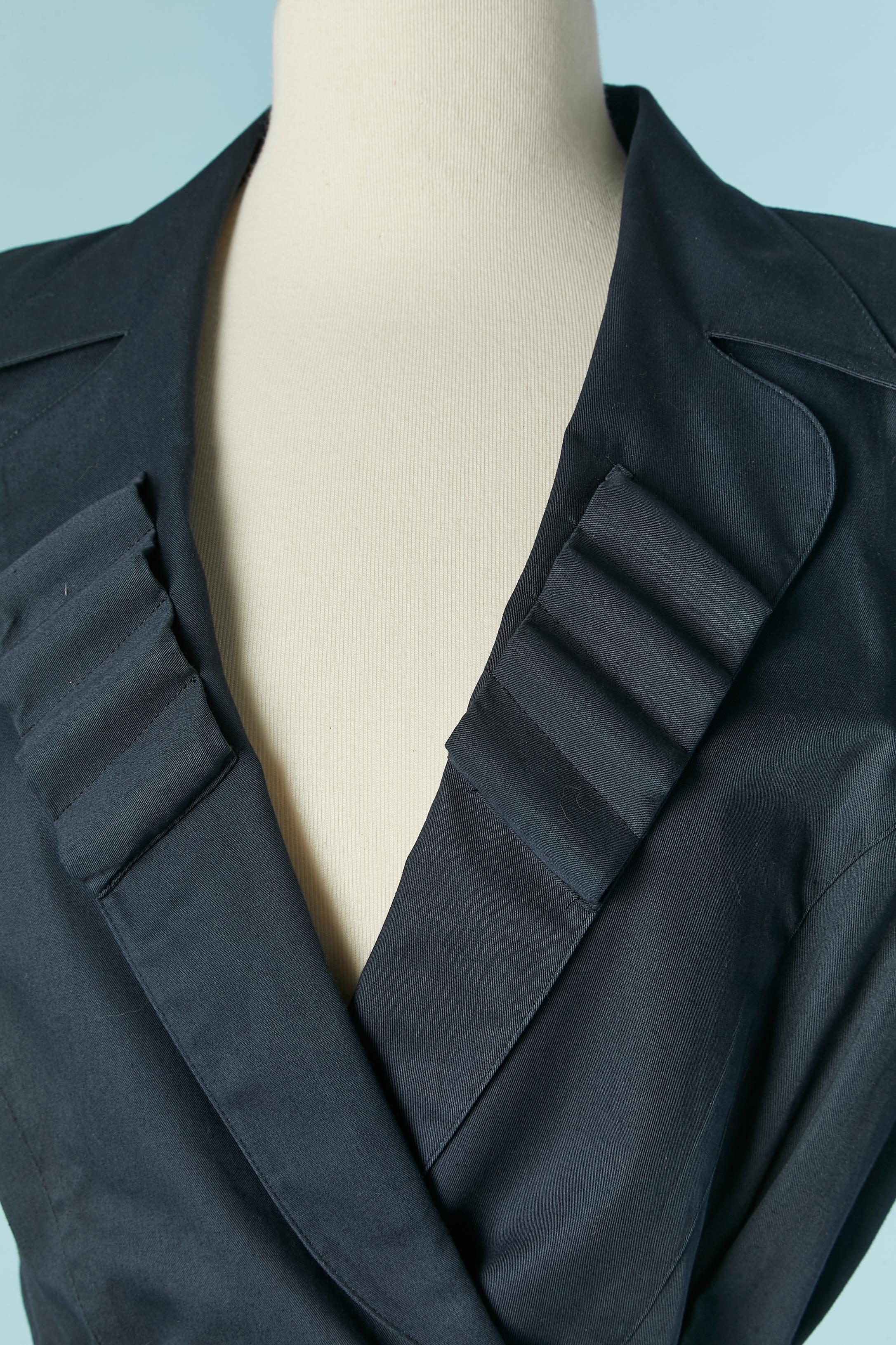 Navy blue cotton skirt suit with belt . No lining inside the jacket but piping and the lining inside the skirt is made of rayon and acetate. Shoulder pad . Snap closure on the front. Belt and buckle. 
SIZE 44 (It) 40 (Fr) M/L 