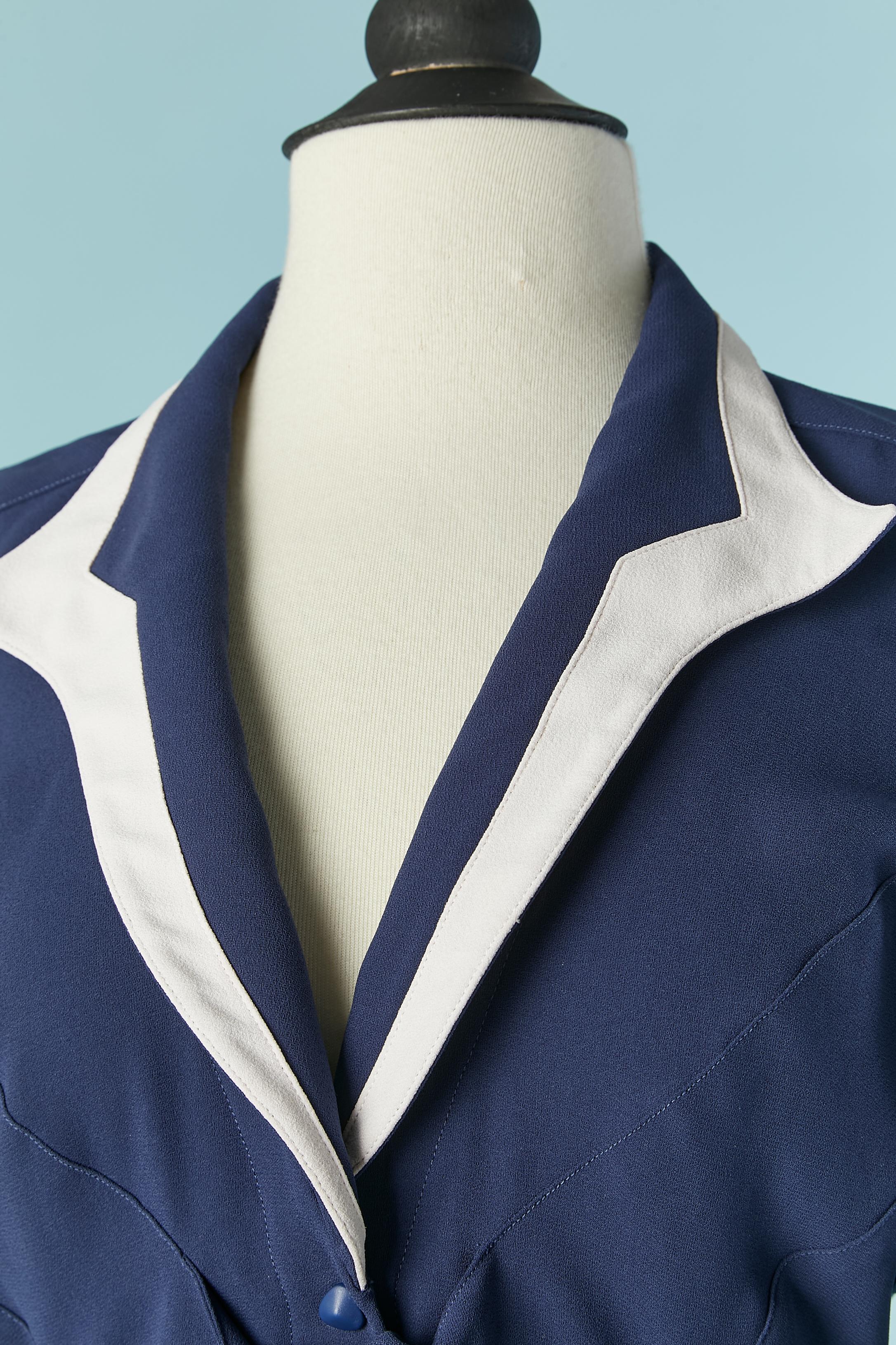 Navy blue crepe dress with white details and bow. 
Fabric composition: 52% rayon, 48% acetate.
Snap closure on the middle front and 2 snap on the back. 
SIZE S ( very small waist)