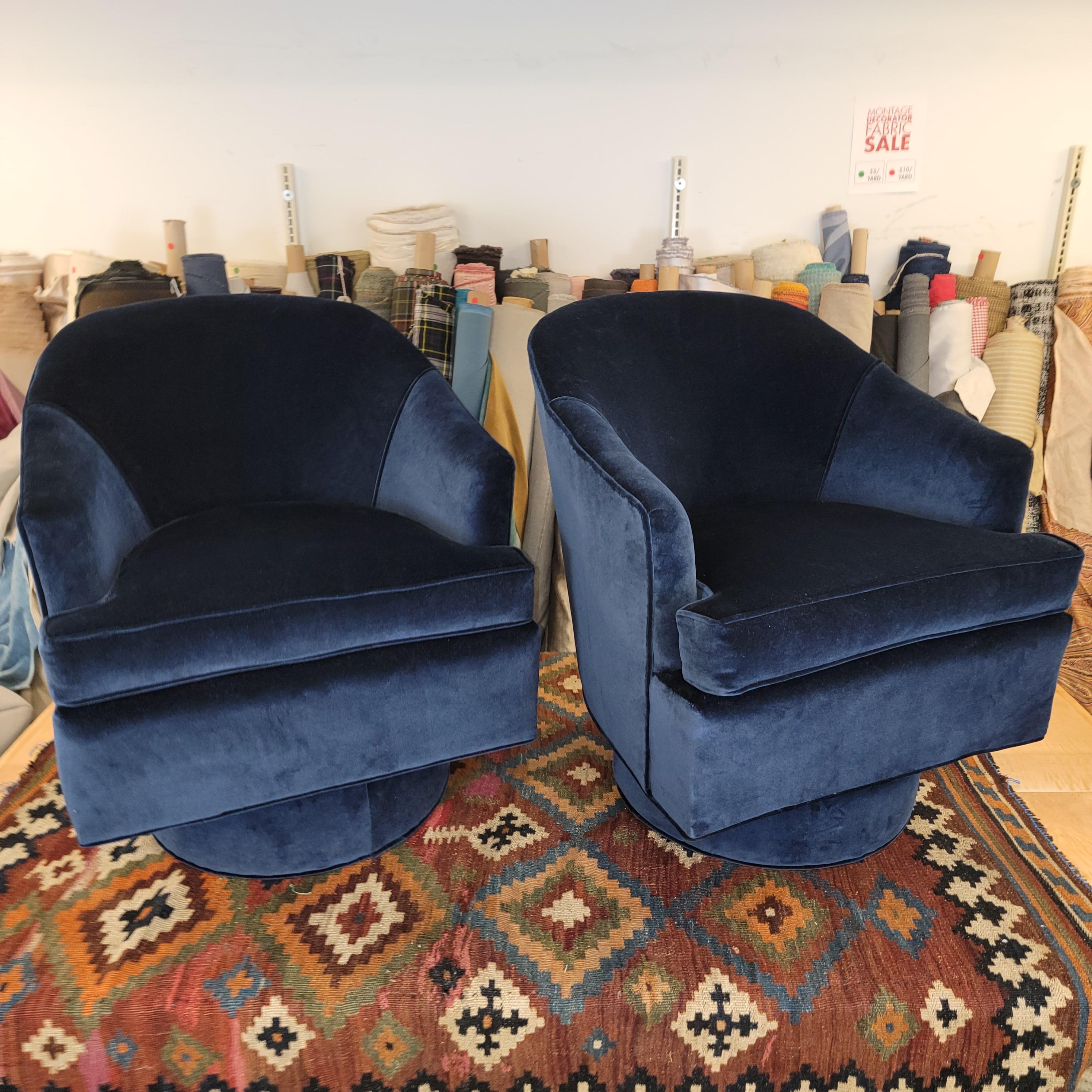 The tapered back and sophisticated tapered arms set these swivel tub chairs apart from the pack. Reupholstered in navy velvet, a timelessly bold color and reequipped with a heightened base which makes the chair a breeze going up or down. Swivel tub