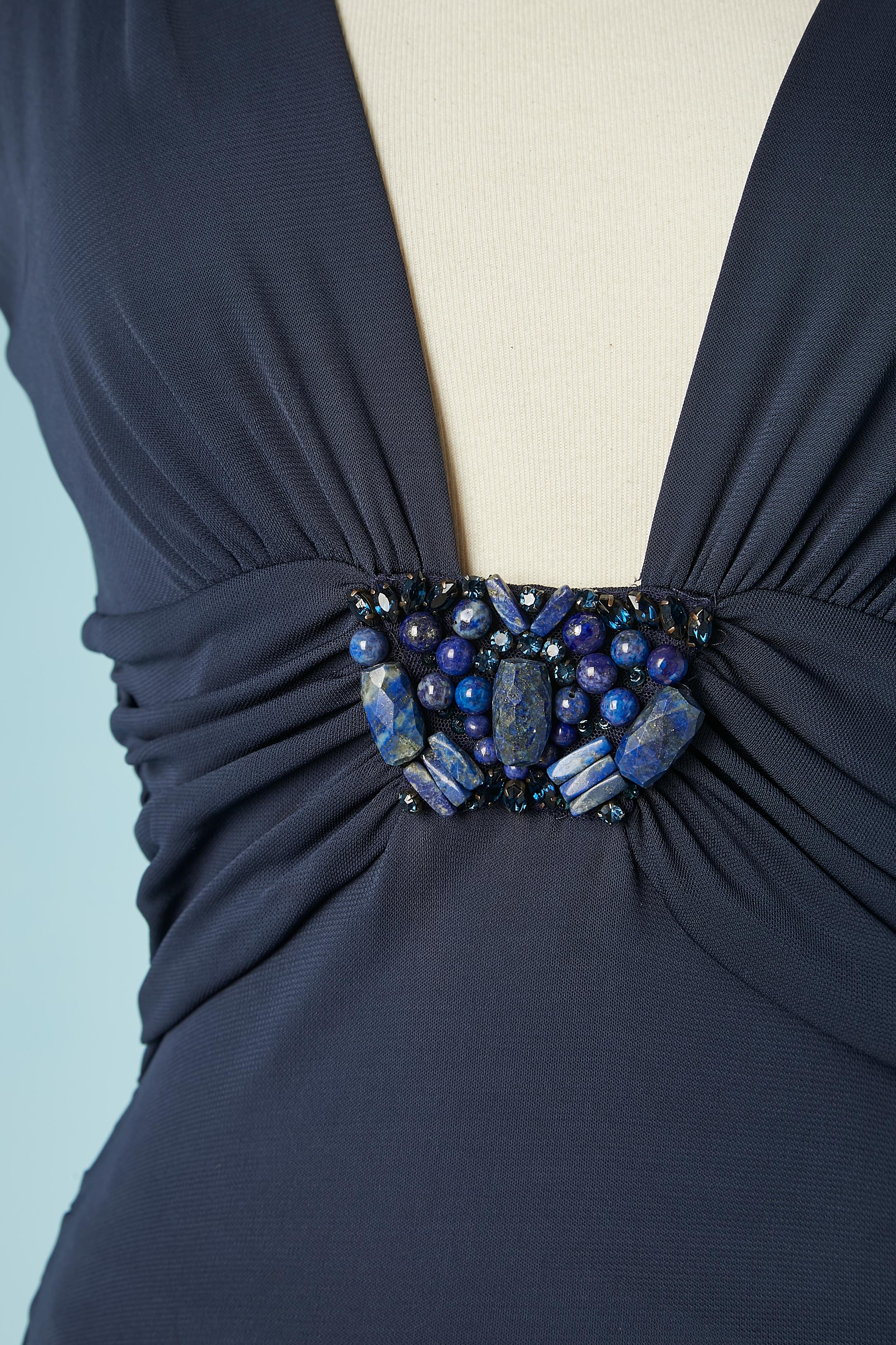 Navy blue evening dress draped and beadwork on the waist . Fabric composition dress and lining : 100% rayon.
Zip on the left side with branded zip-puller. 
Split in the middle front, lenght = 65 cm
SIZE M
