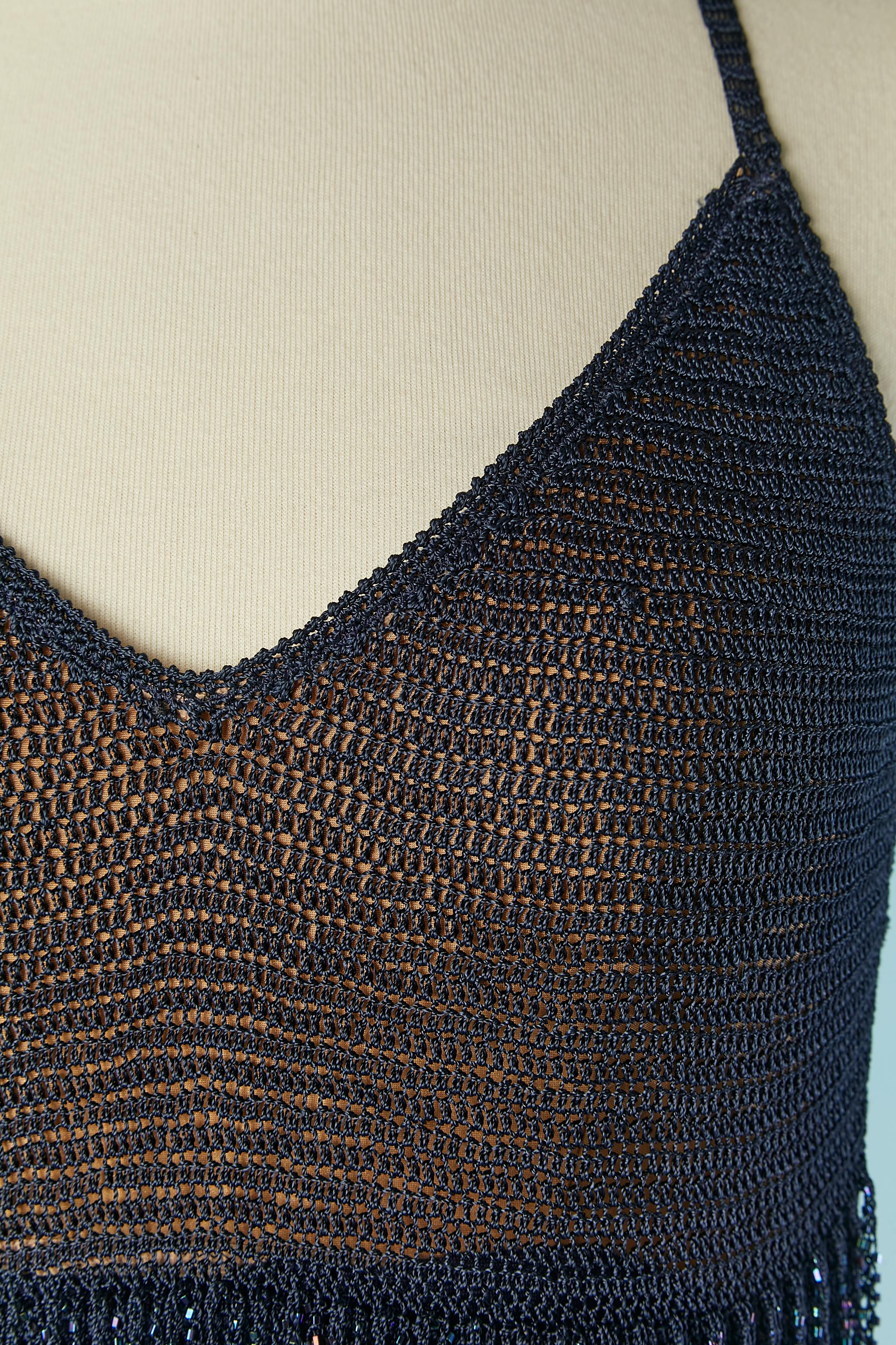 Backless Navy blue knit cocktail dress with beaded fringes embellishment. Knit composition: 100% rayon. 
Gold jersey lining inside the bust and navy jersey lining inside the skirt. 
SIZE 44 (It) 40 (Fr) M 
