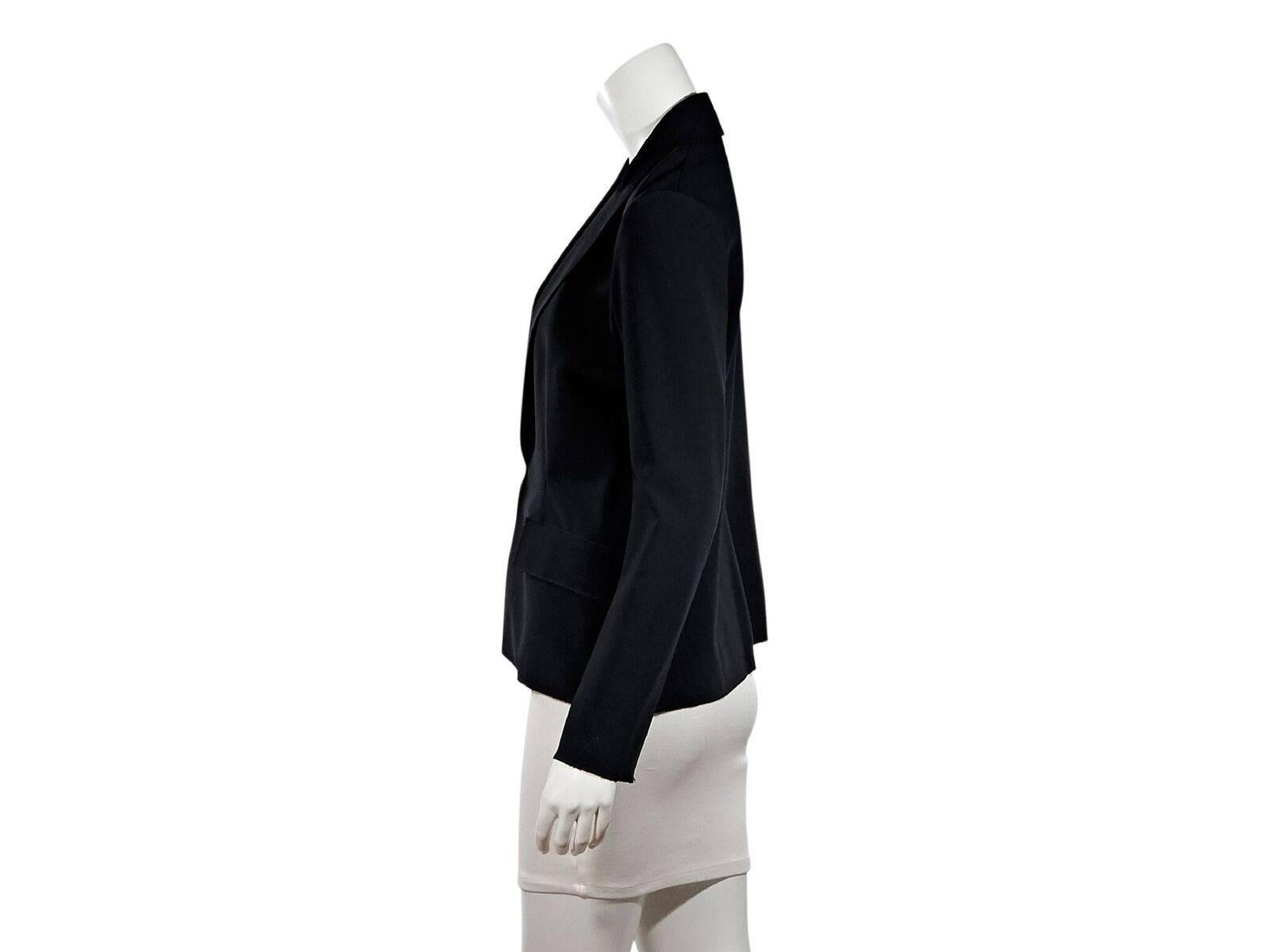Product details:  Navy blue blazer by Lanvin.  Long sleeves.  Notched lapel.  Hook closure.  Waist flap pockets.  40