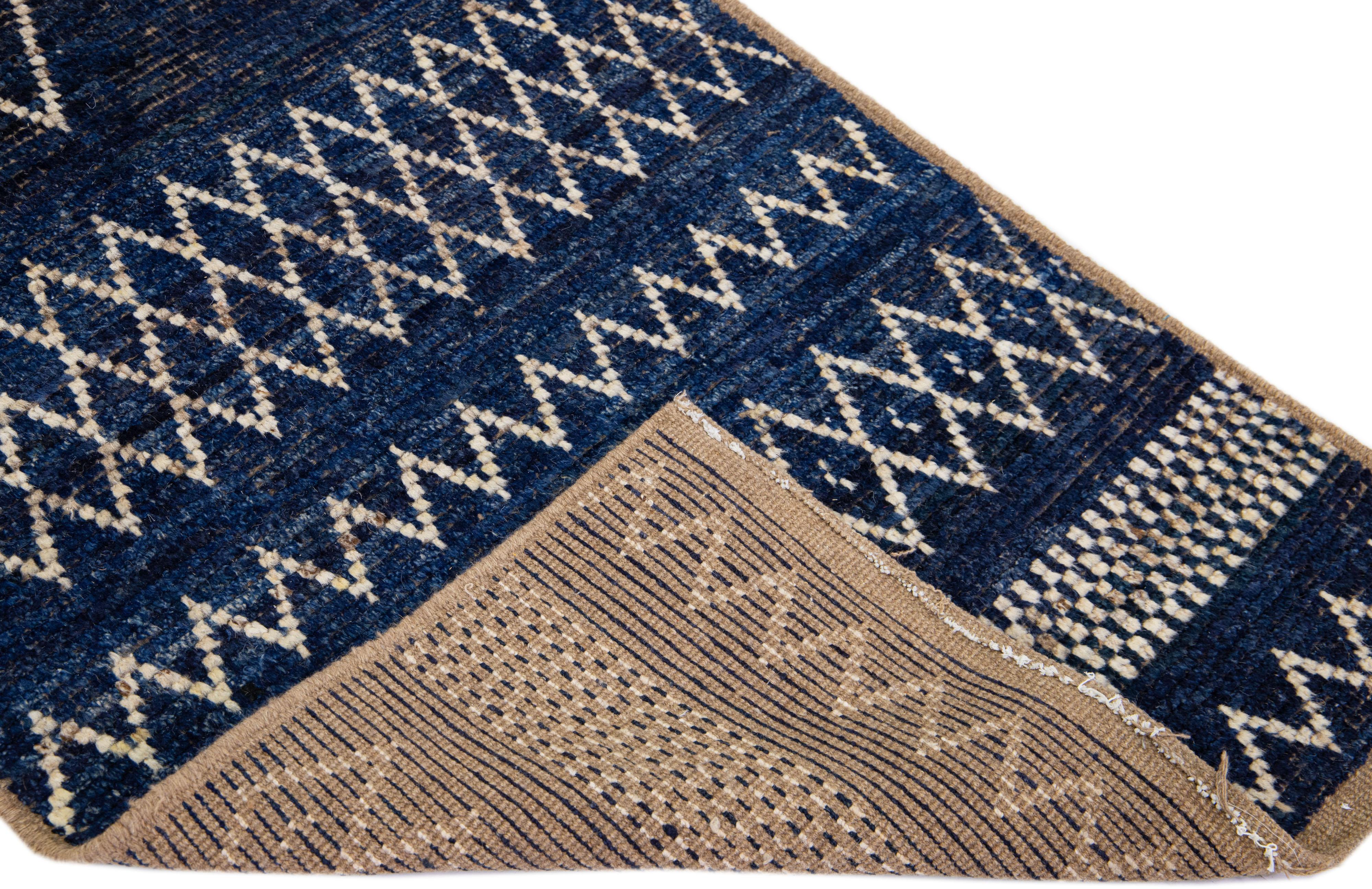 Beautiful Moroccan-style handmade wool rug with a navy blue field. This Modern rug has light brown and ivory accents featuring a gorgeous all-over geometric tribal design.

This rug measures: 2'10