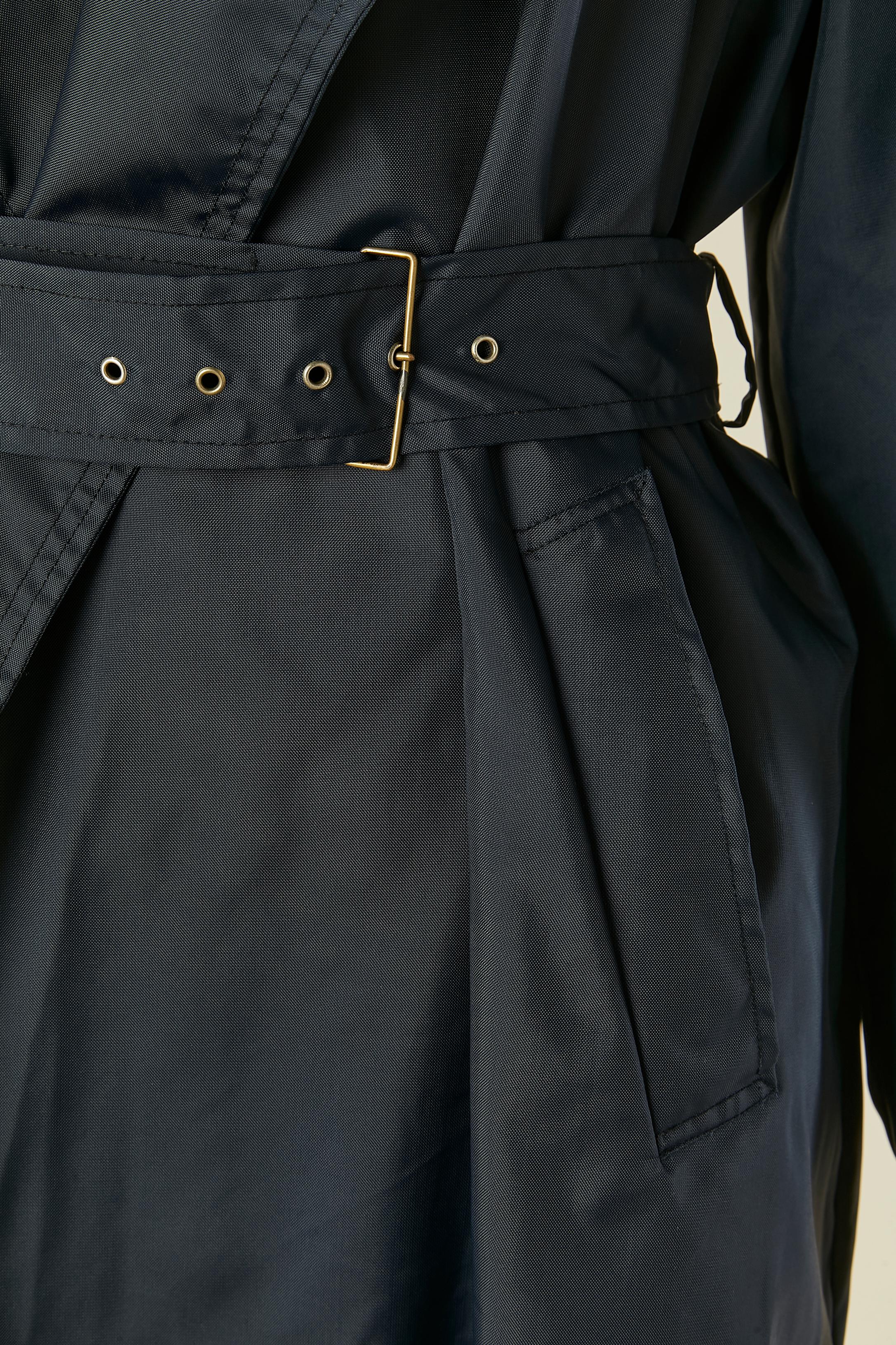 Impermeabile in nylon raglan blu navy con cintura e fibbia. Fodera in cotone. 
Tasca su entrambi i lati 
TAGLIA 42 (It) 38 (Fr) M 