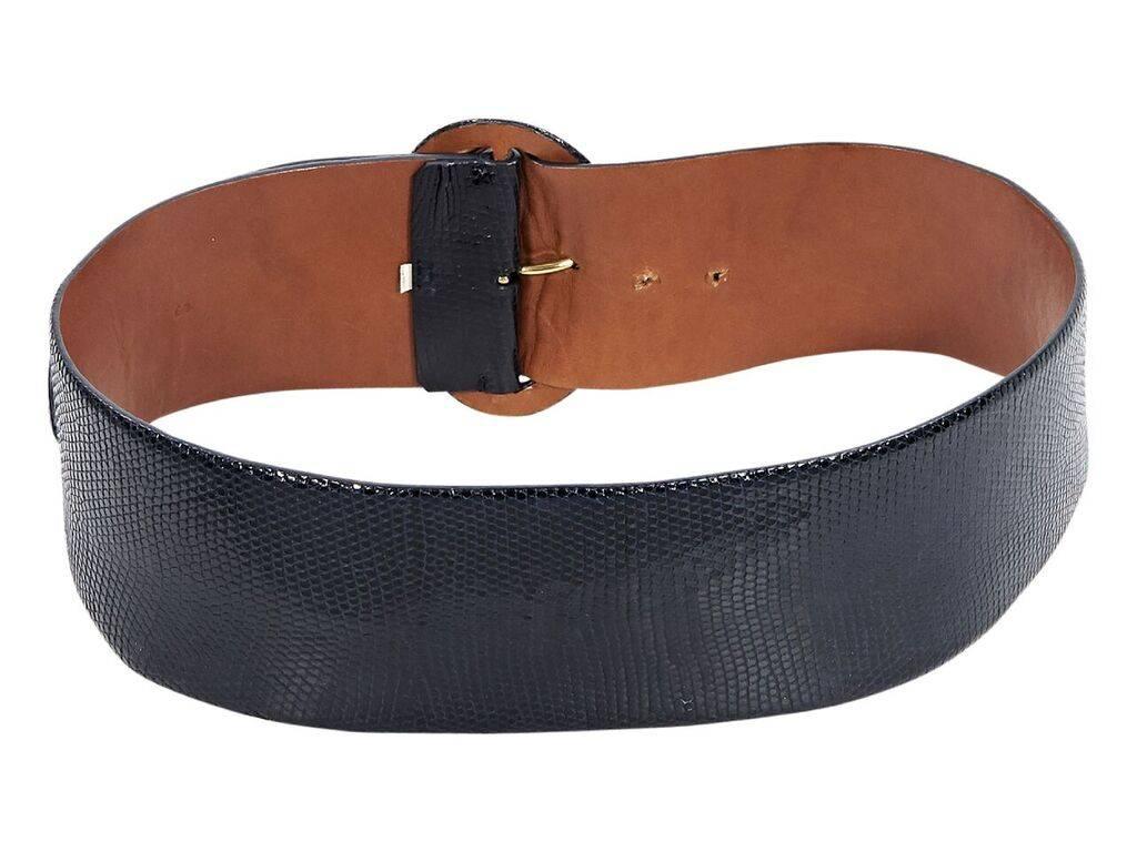 Product details:  Navy blue wide lizard belt by Ralph Lauren.  Adjustable buckle closure.  Goldtone hardware.  3