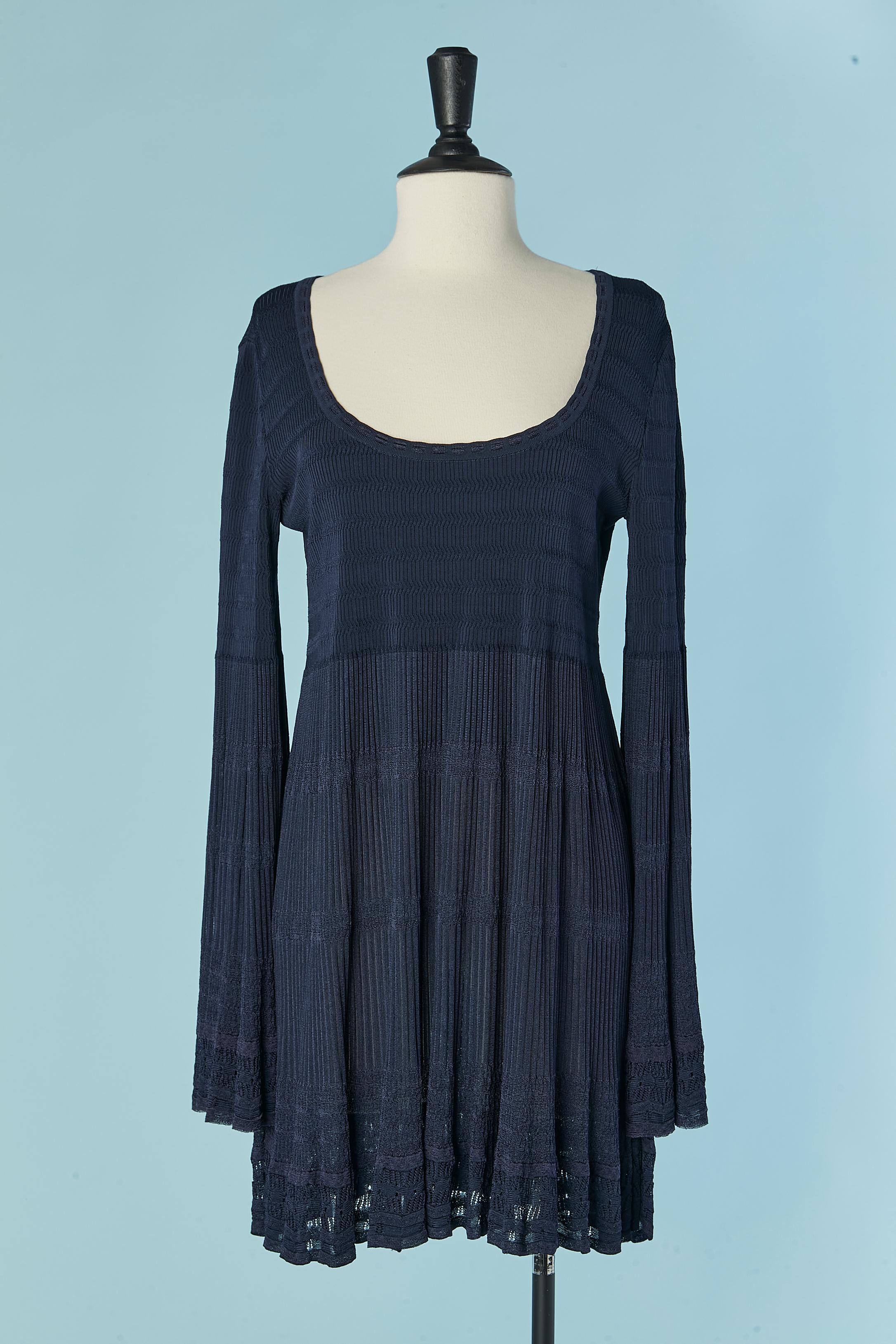 Navy blue rayon knit dress with wide sleeves. Knit composition: 68% rayon, 8% nylon, 22% silk, 2% elastane.
The knitting is different and more see-through from the under bust until the bottom edge. Same on the sleeves. 
SIZE 44 (It) 40 (Fr) L 