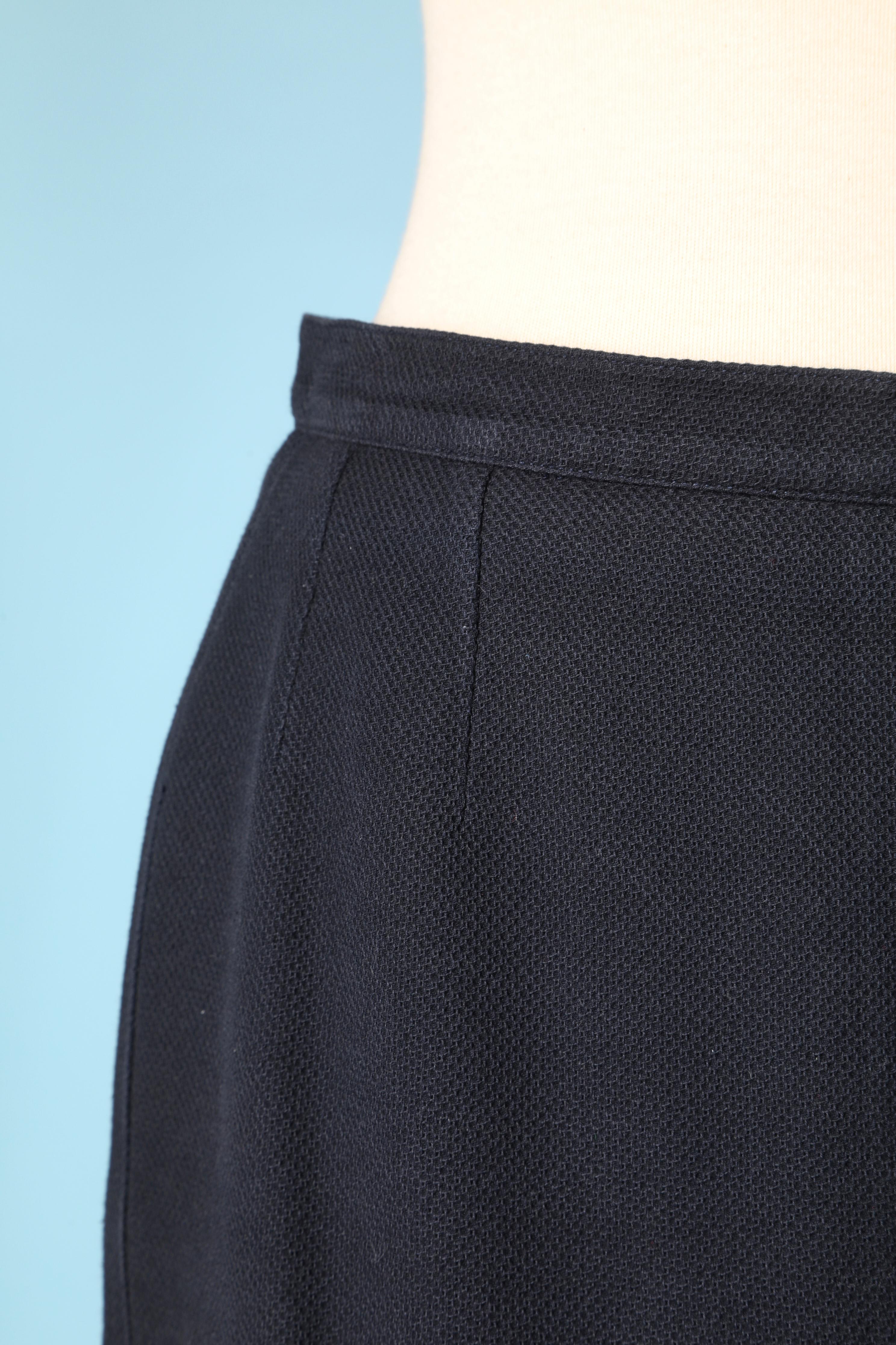 Navy blue skirt with button on the middle back. Silk lining. Zip and hook&eye closure on the middle back. 
Split on the middle back on the bottom with branded button and buttonhole closure 
SIZE 38 (Fr) M 