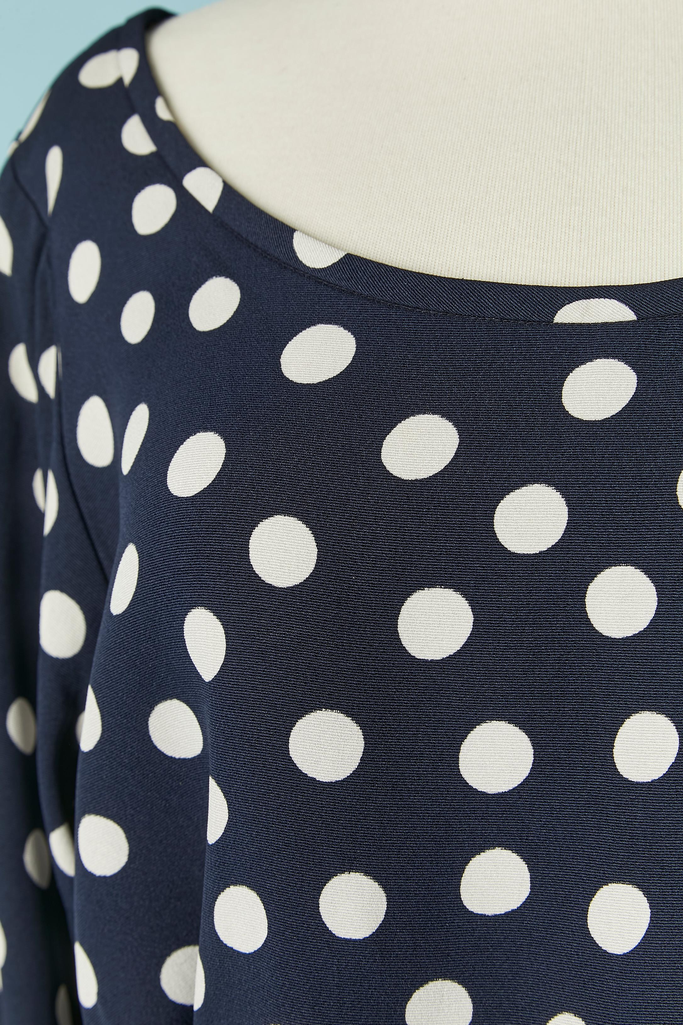 Navy blue top and wrapped skirt ensemble with white Polka dots. The fabric composition tag has been cut but the fabric composition is probably rayon. 
SIZE OF THE TOP: 40 (FR) L 
SIZE OF THE SKIRT : 38 (Fr) M 
