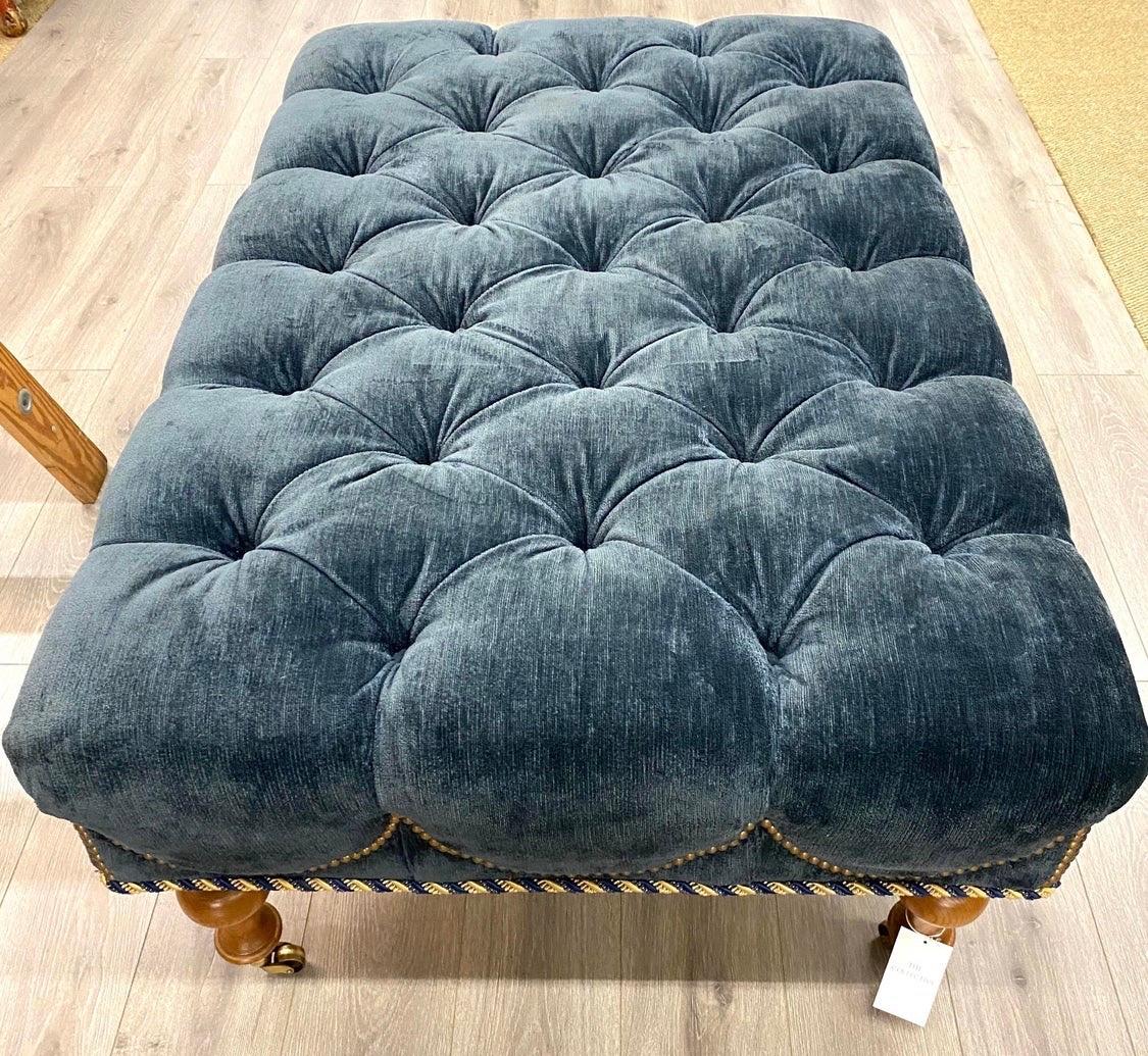 Elegant chesterfield style tufted ottoman with great scale. See dimensions below.
Gorgeous blue velvet fabric is enhanced by perimeter cording. The ottoman sits on
caster wheels for ease of movement.