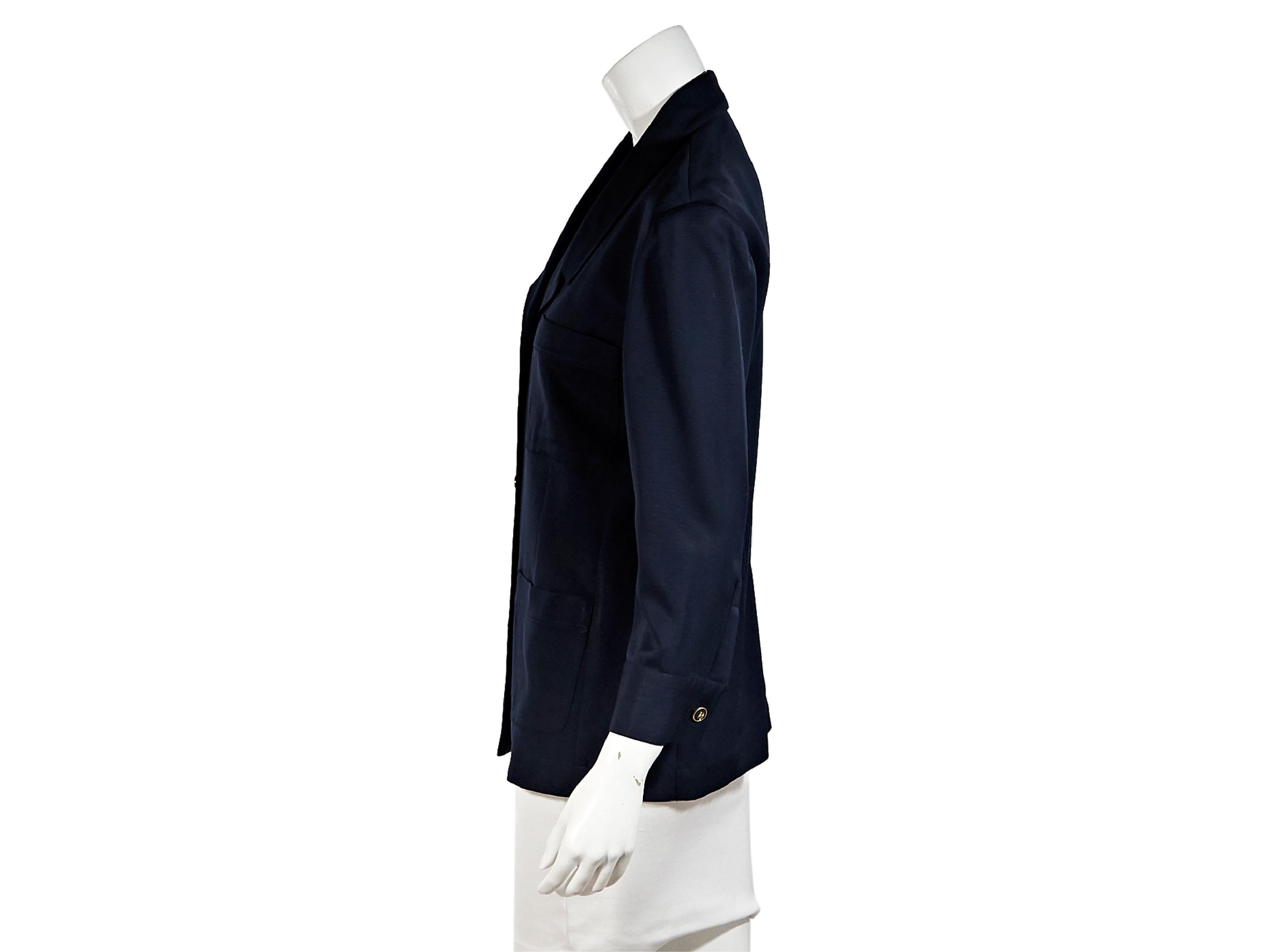 Product details:  Vintage navy blue blazer by Chanel.  Notched lapel.  Long sleeves.  French cuffs.  Button-front closure.  Front patch pockets.  Goldtone hardware.  36