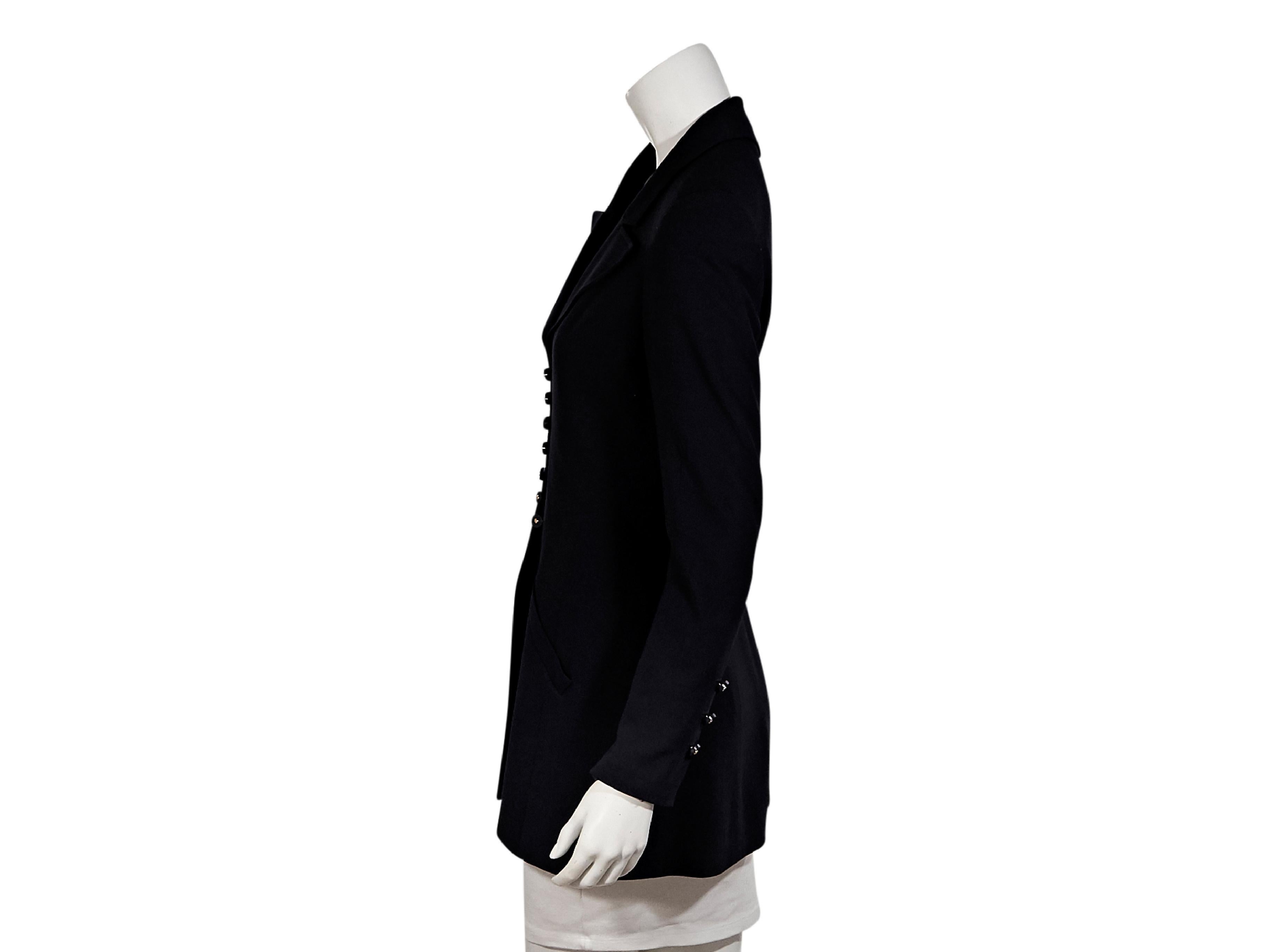 Product details:  Vintage navy blue wool jacket by Chanel.  Notched lapel.  Long sleeves.  Three-button detail at cuffs.  Button-front closure.  36