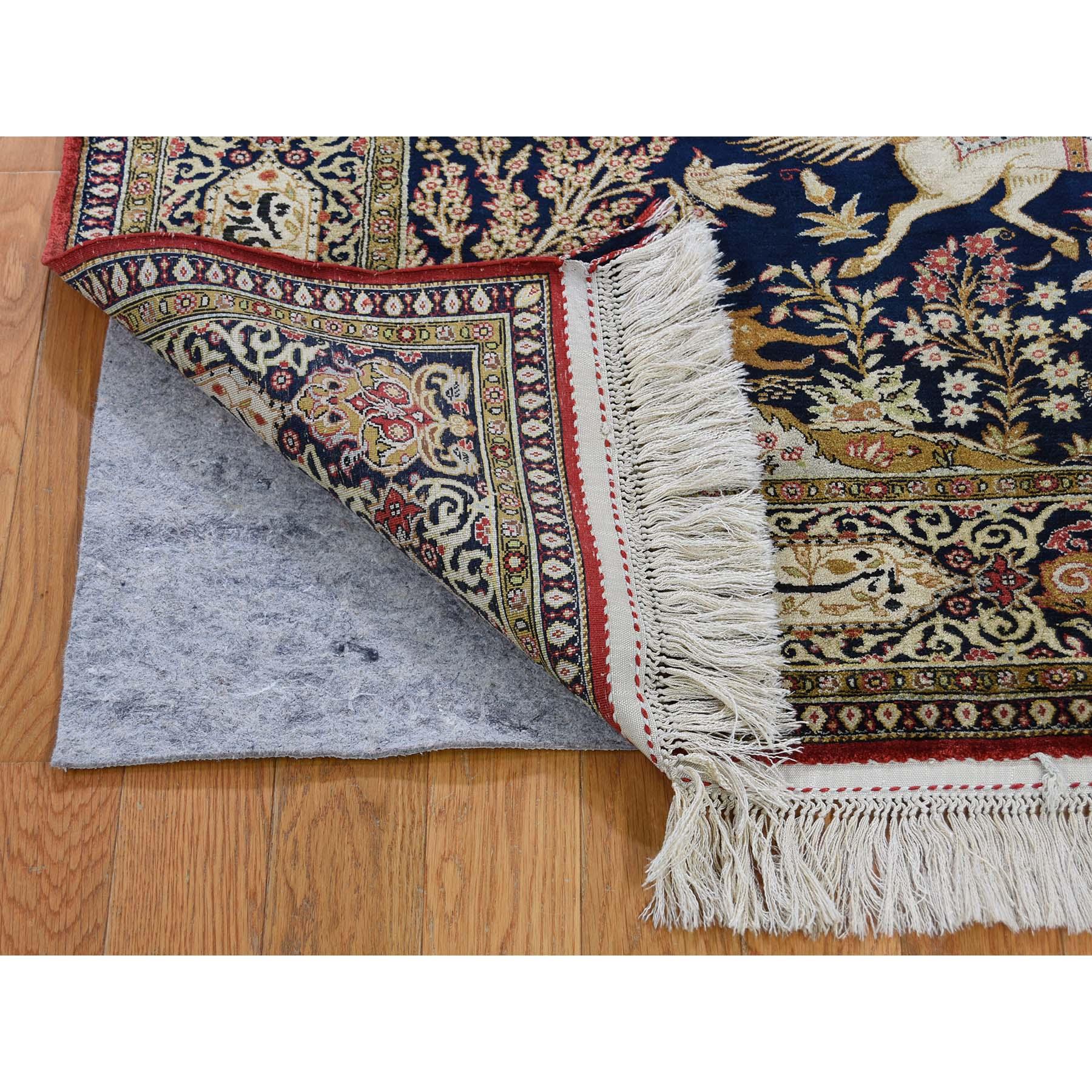 This is a truly genuine one-of-a-kind navy blue vintage Persian silk Qum hunting design with poetry rug. It has been knotted for months and months in the centuries-old Persian weaving craftsmanship techniques by expert artisans.
Primary materials: