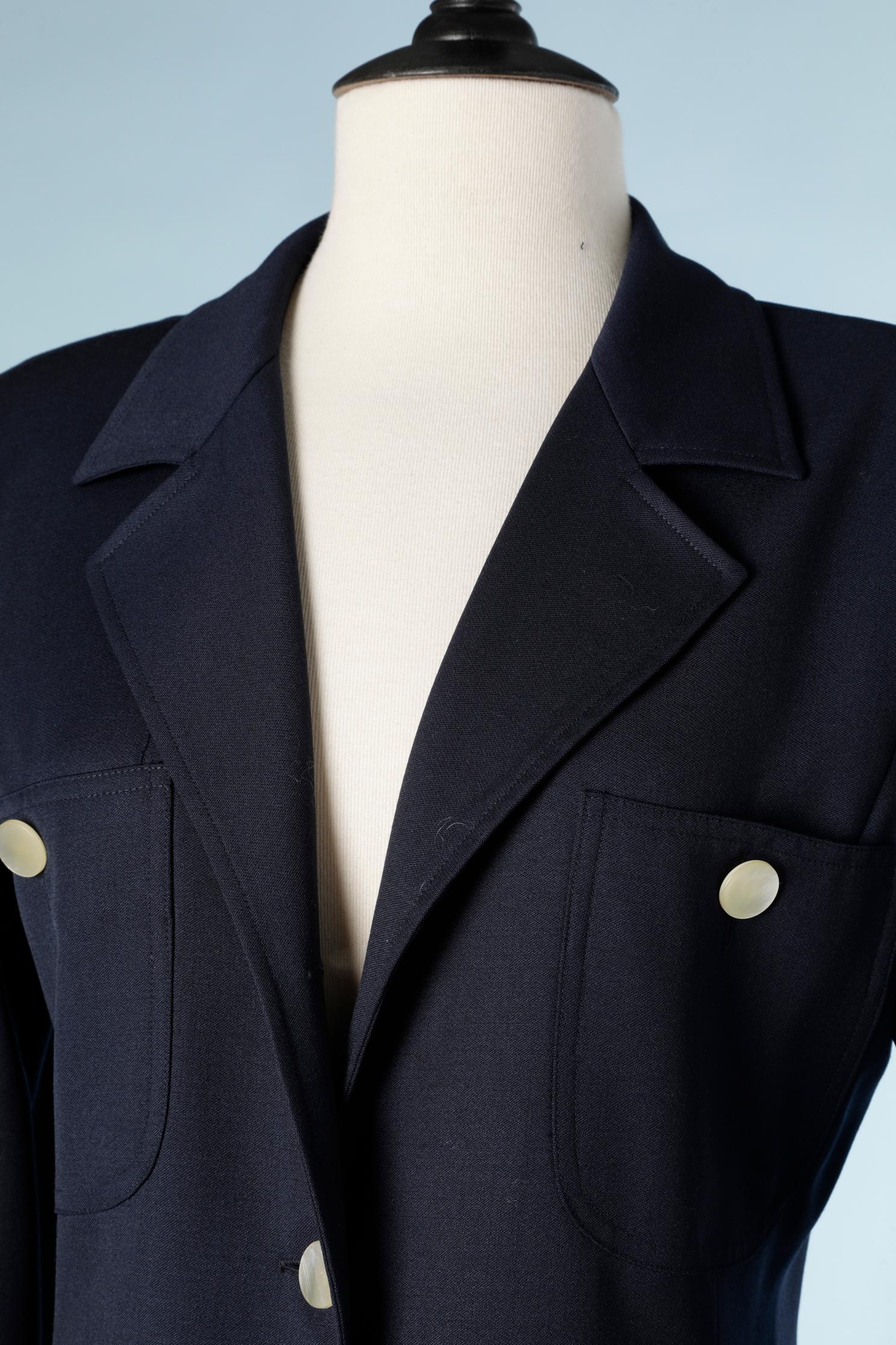 Navy blue wool dress with mother-of-pearls buttons. 
SIZE 8 (M)