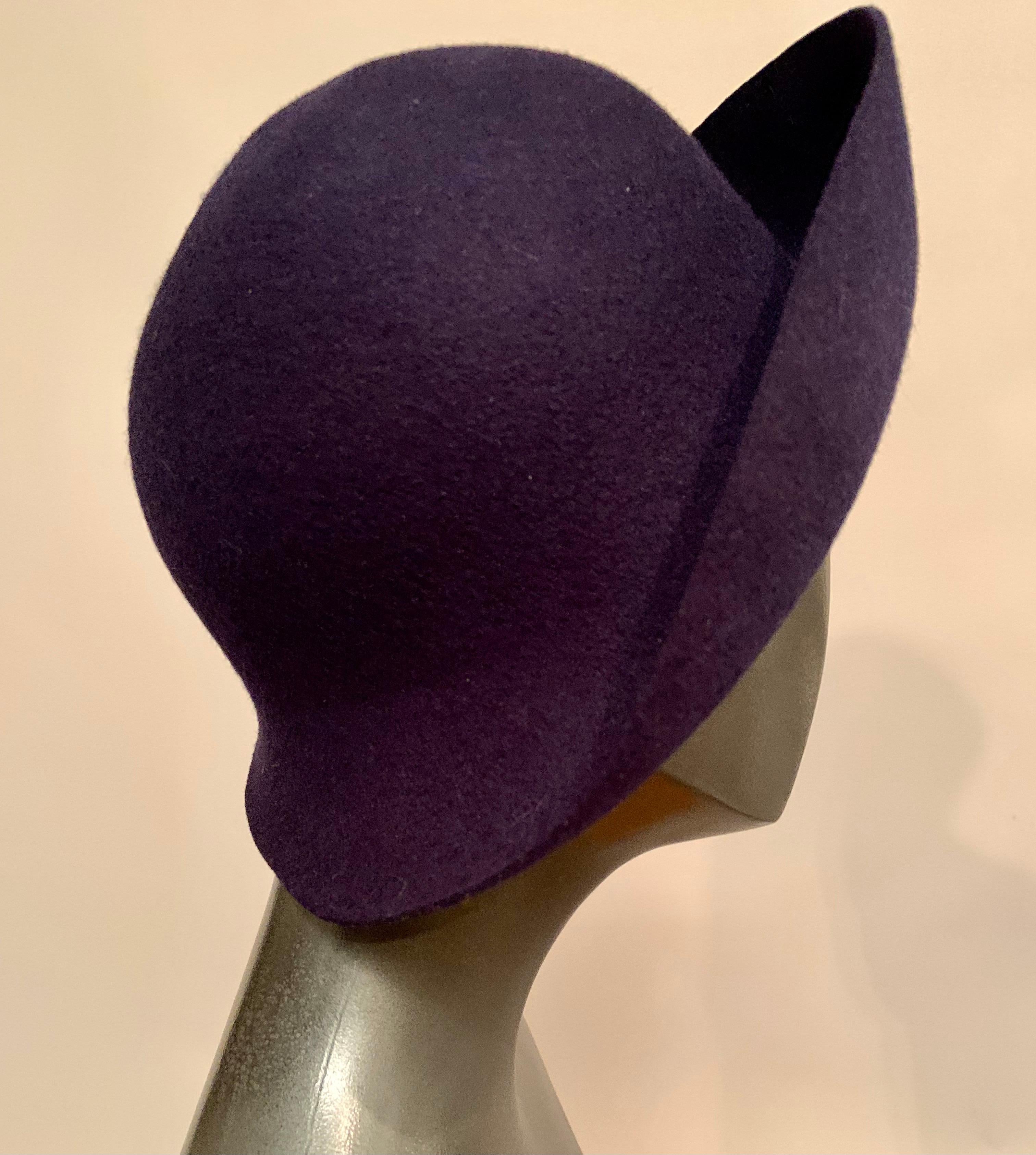 A chic little navy blue wool felt hat has a face flattering turned back brim. Wear it as is, or add a scarf, ribbon or pin for a different look. It was retailed by John Wanamaker in Philadelphia and it is in excellent condition.
Measurements; 