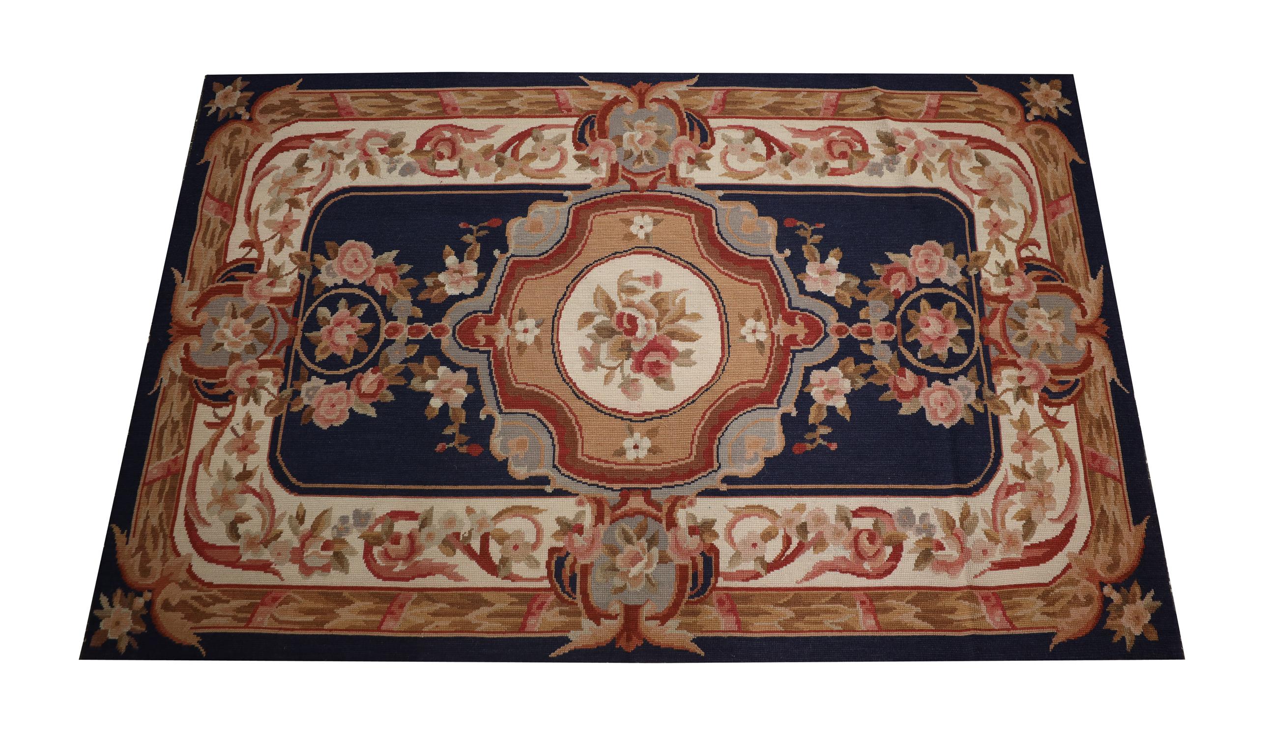 Beautifully hand-woven, this needlepoint rug is sure to make the perfect accent for any room. The design features a traditional colour palette of deep blue beige and cream with pink accents that make up the flower details. Both the design and