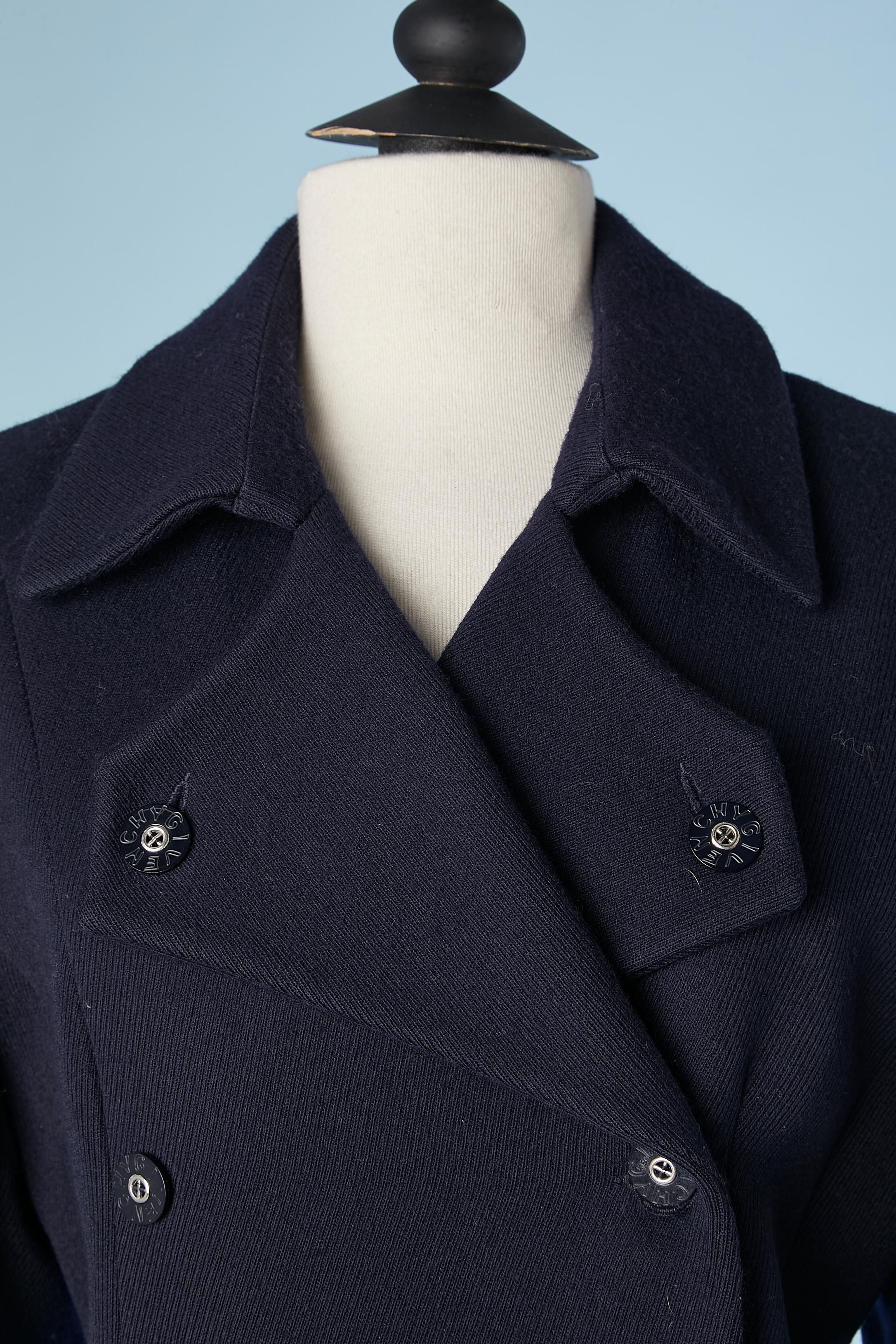 Navy blue wool peacoat. Fabric composition: 100% wool. Changing color lining ( blue and purple) 100% acetate. Branded buttons. 
SIZE 40 (L) 