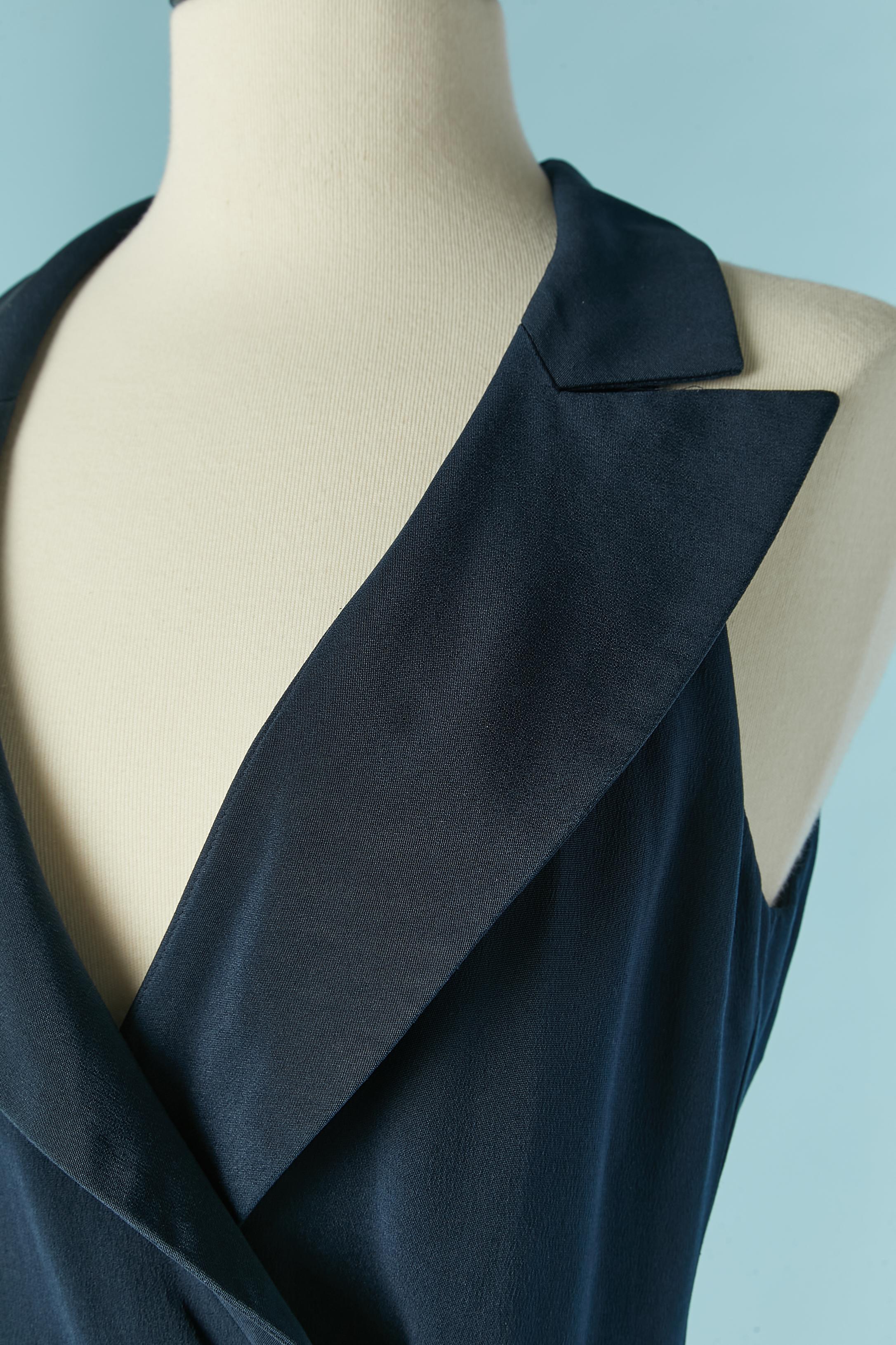 Navy blue wrapped sleeveless dress. No fabric tag composition but the shell fabric is probably rayon and the lining in silk. 
Gold metal decorative button on the middle front with hook&eye underneath. Waist band inside with hook&eye closure. 
SIZE
