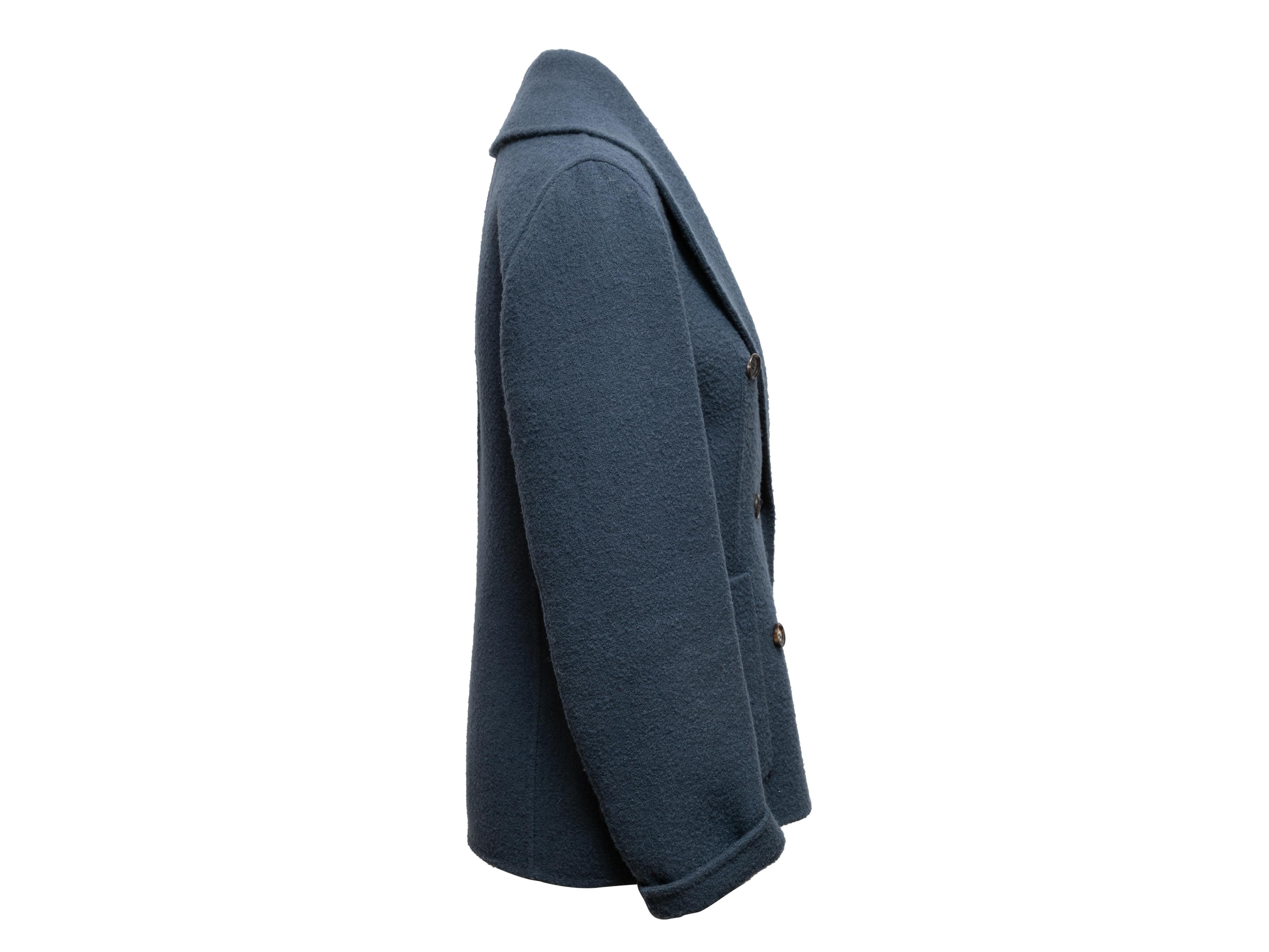 >Navy double-breasted wool jacket by Celine. Shawl collar. Dual hip pockets. Button closures at front. 40