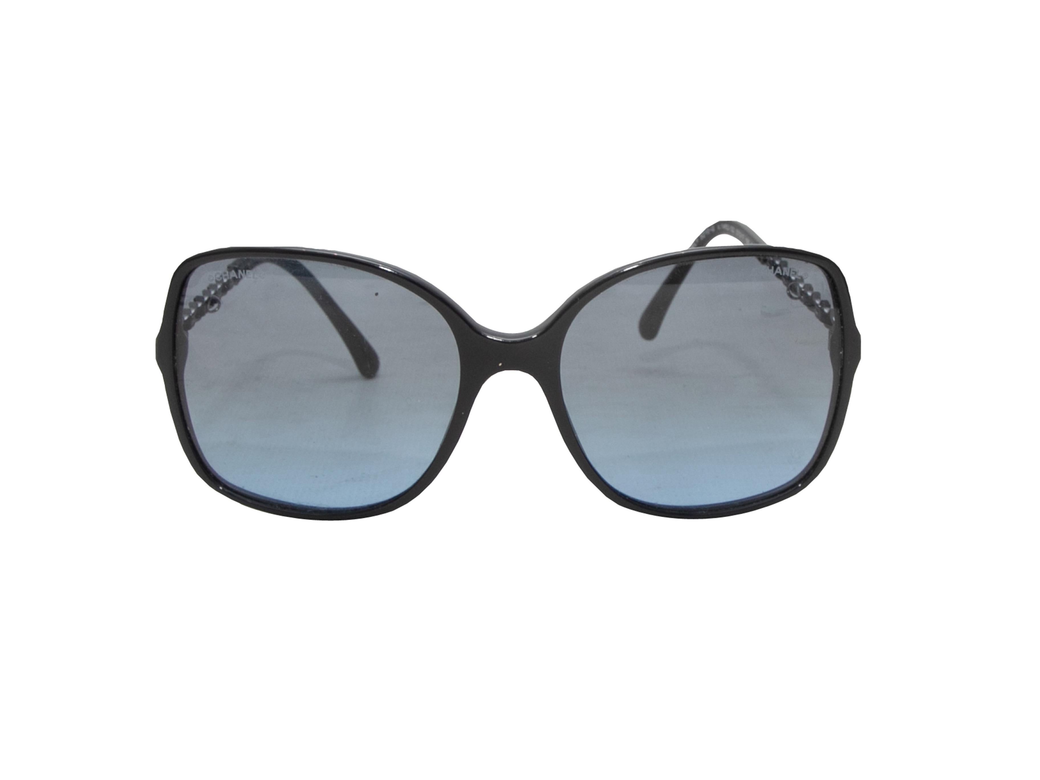 Navy acetate oversized sunglasses by Chanel. Chain-link detailing at arms. Optional logo chain-link and leather glasses strap. 2.25