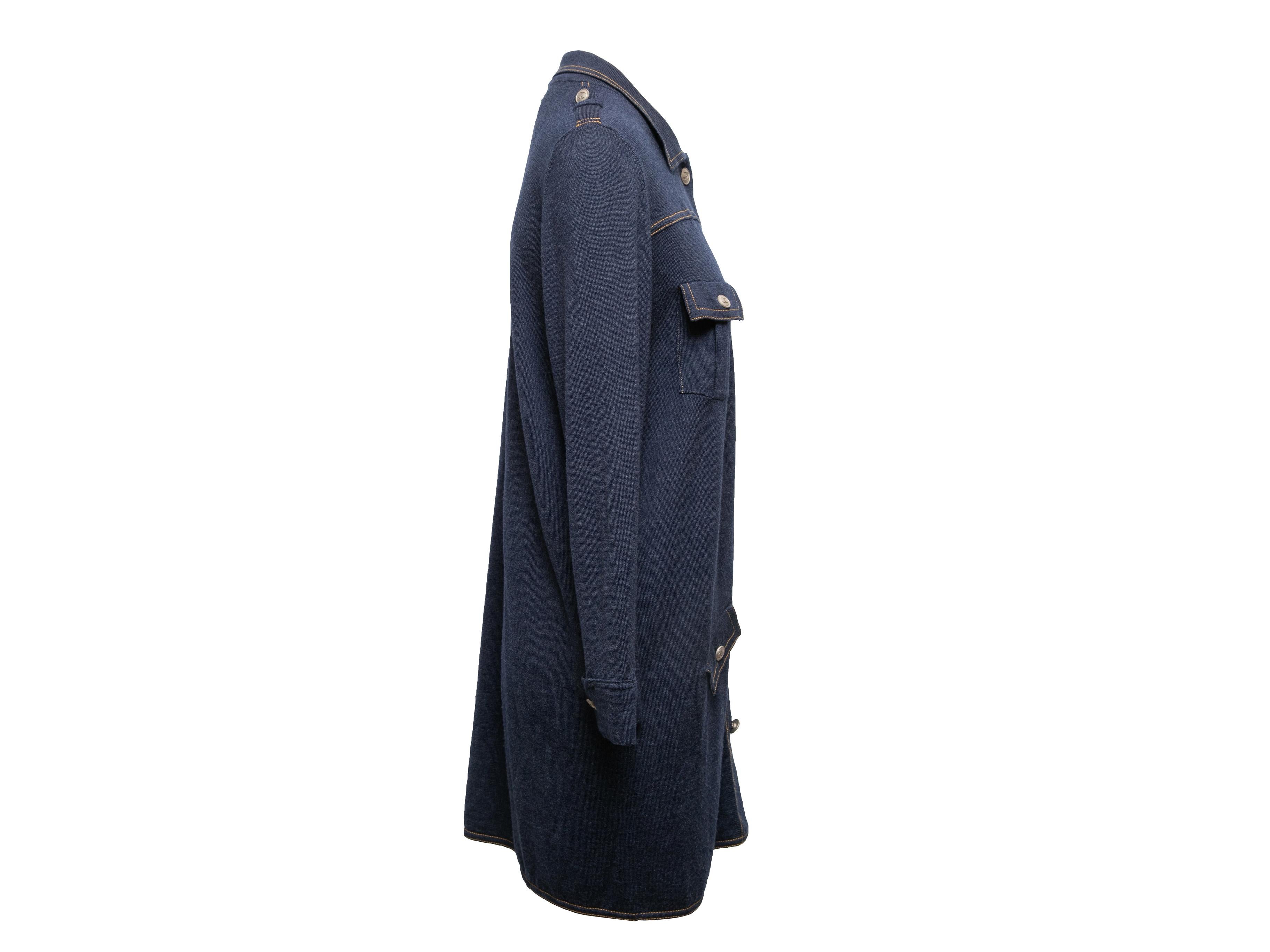 Navy wool and silk-blend knit dress by Chanel. Contrast stitching throughout. Pointed collar. Long sleeves. Four pockets. Button closures at center front. 41