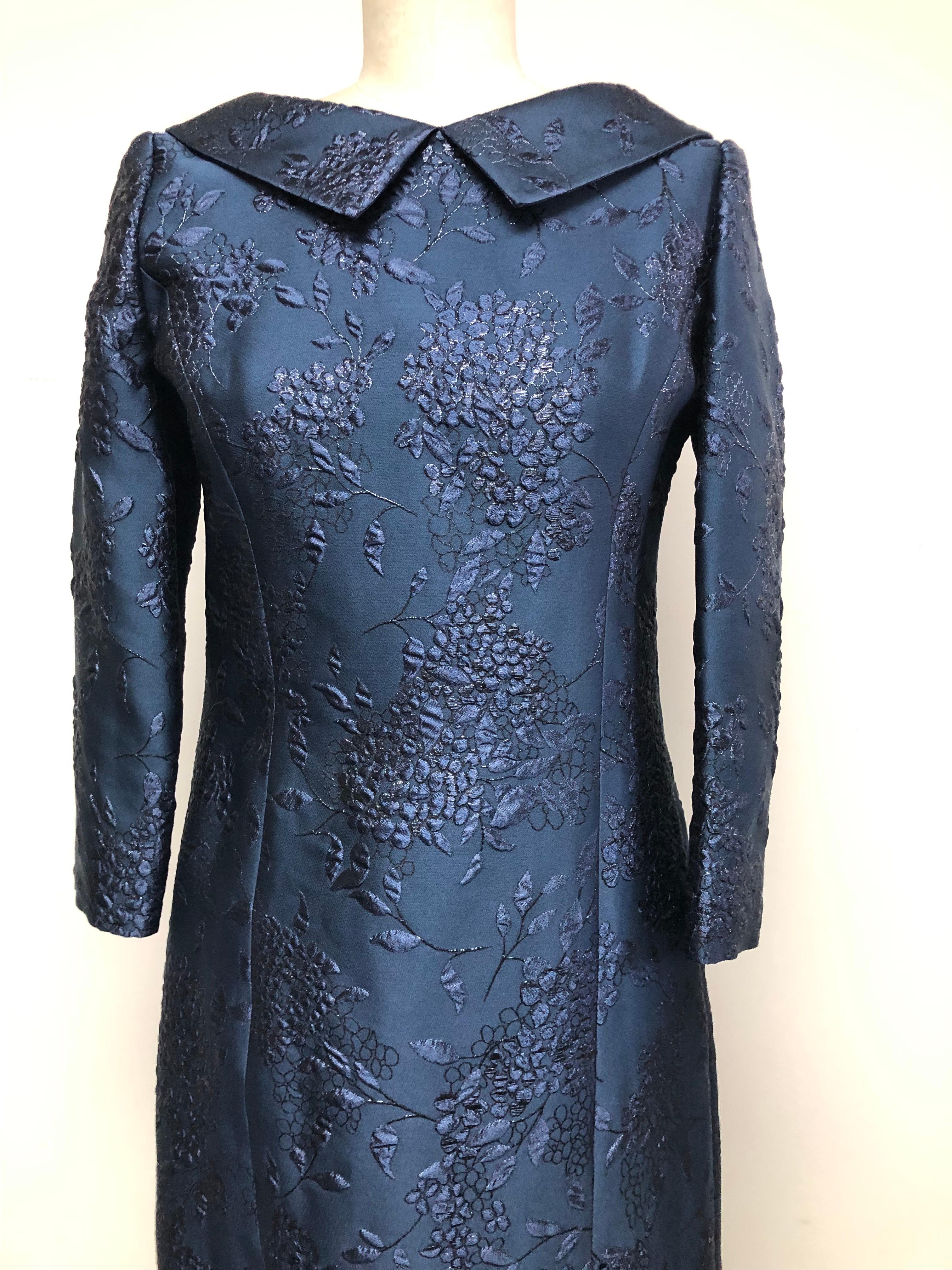 Navy lilac floral French brocade loose fitting slim dress with 3 /4 sleeves. The collar drapes uniquely to the back into elegant gathers. Comfortable and chic—easily transitions from day into evening. A Belle du Jour inspired design with a shimmer.