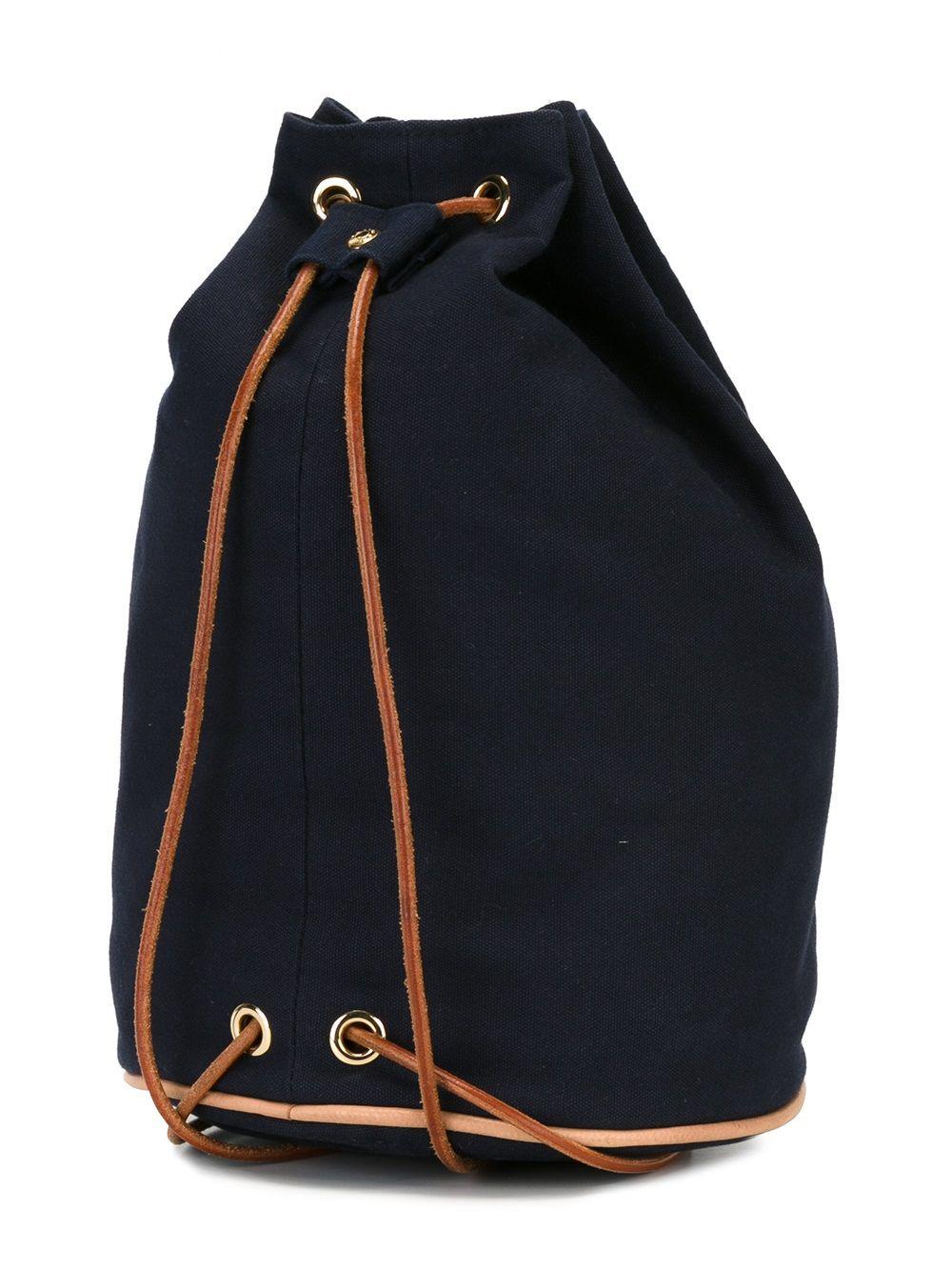 Hermès navy cotton shoulder bag “Matelot-Marin” featuring a front embroidered logo, a leather drawstring backpack, a natural leather shoulder tie and a fabric logo label.  100% cotton. 
Circa1990s 36cm X Diameter 24cm 
In good vintage condition .