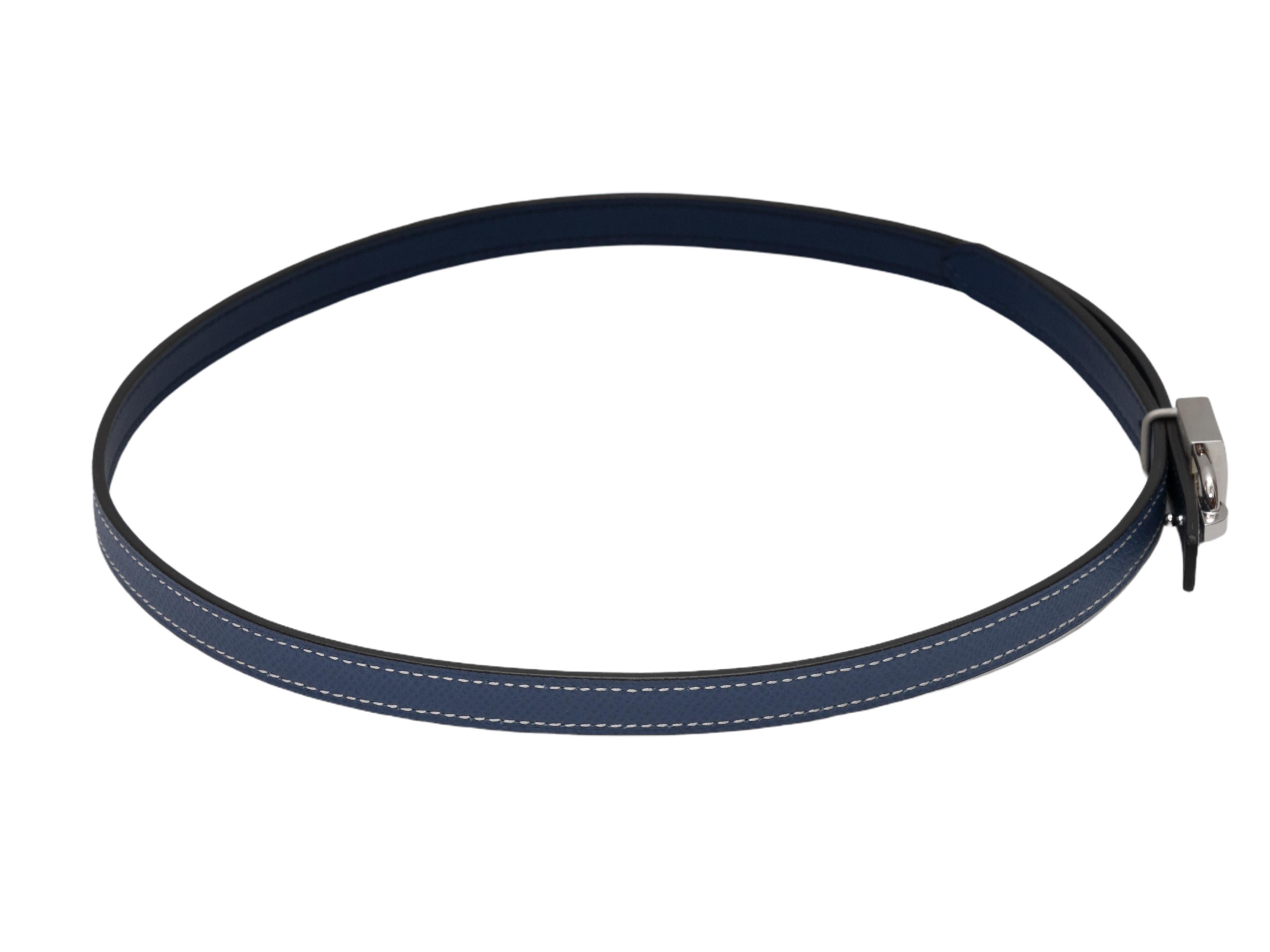 Navy skinny leather belt by Hermes. Silver-tone lock buckle closure. 0.5