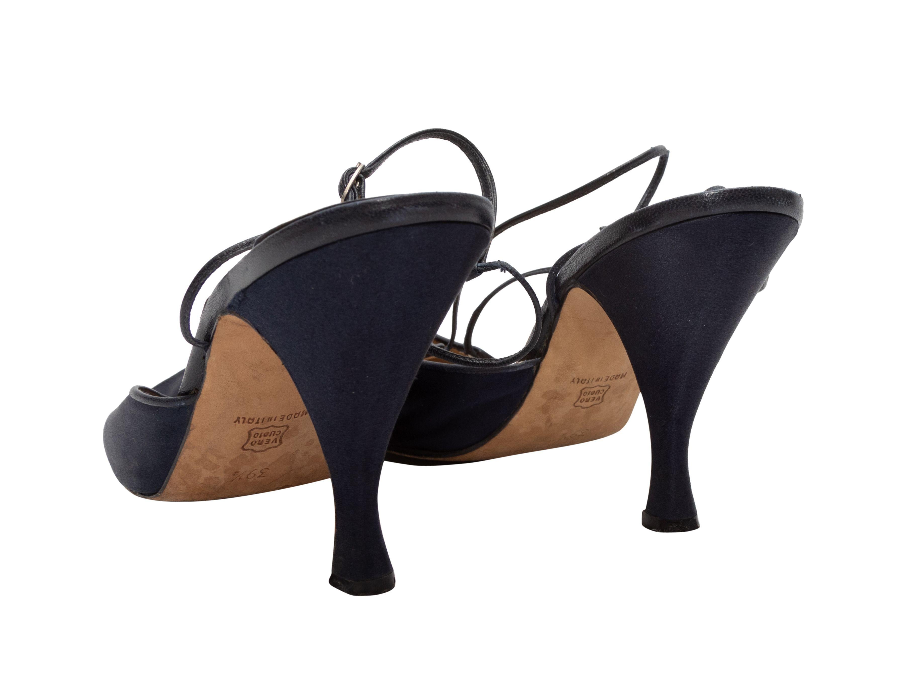 Navy satin pointed-toe heels by Manolo Blahnik. Silver-tone buckle closures at ankle straps. 4