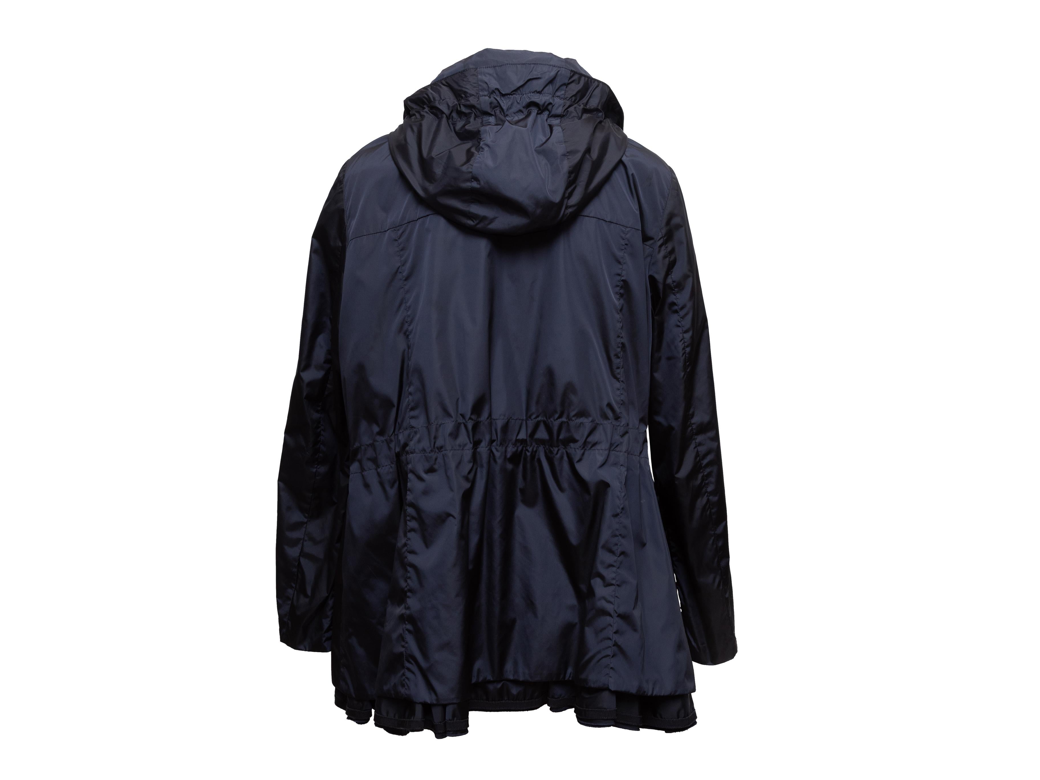 Navy hooded windbreaker jacket by Moncler. Dual flap pockets at hips. Front zip closure. Designer size 5. 44