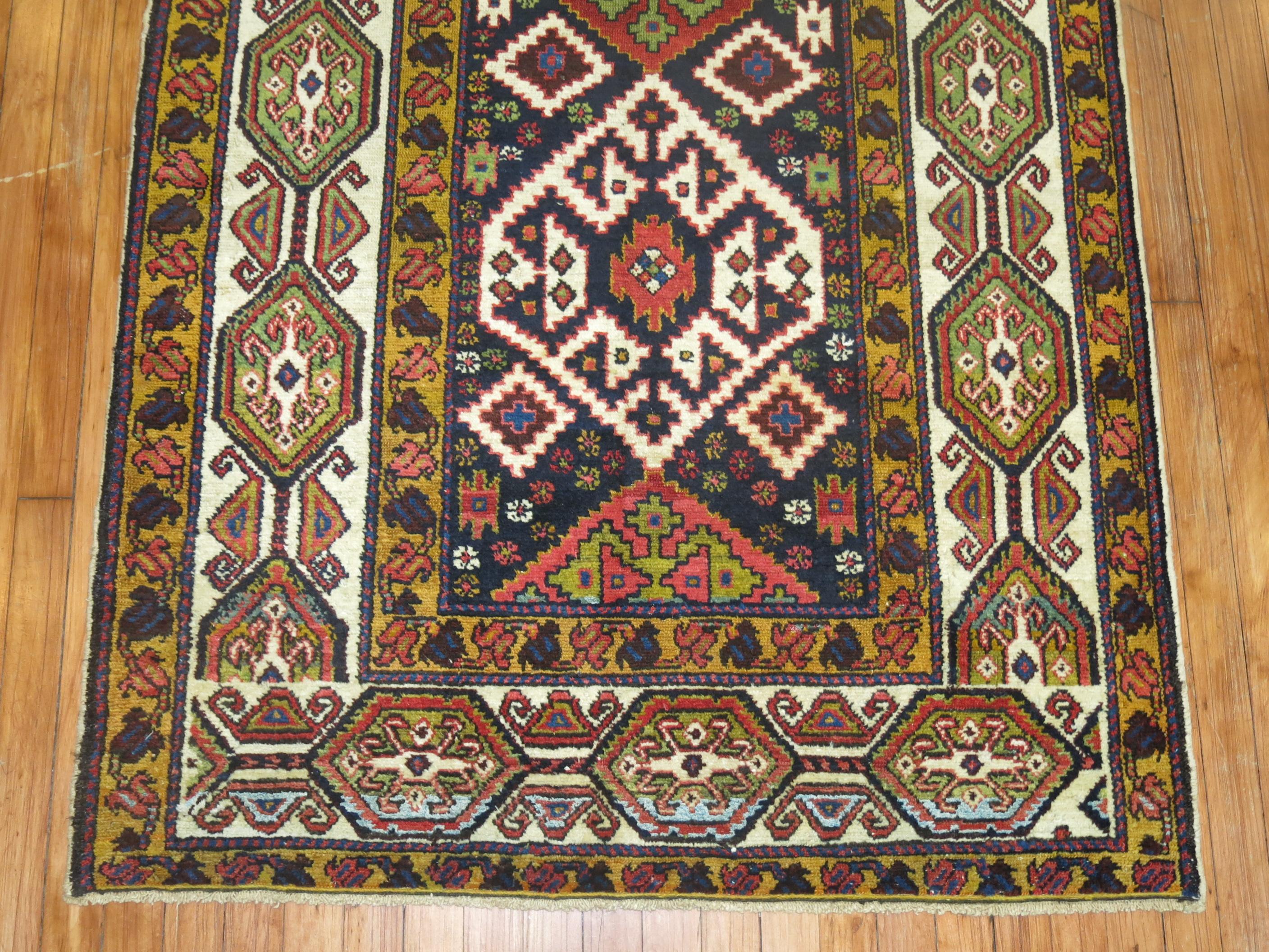 Colorful Persian Bakhtiari runner with a geometric design on a navy ground, circa 1930.

Measures: 3'9