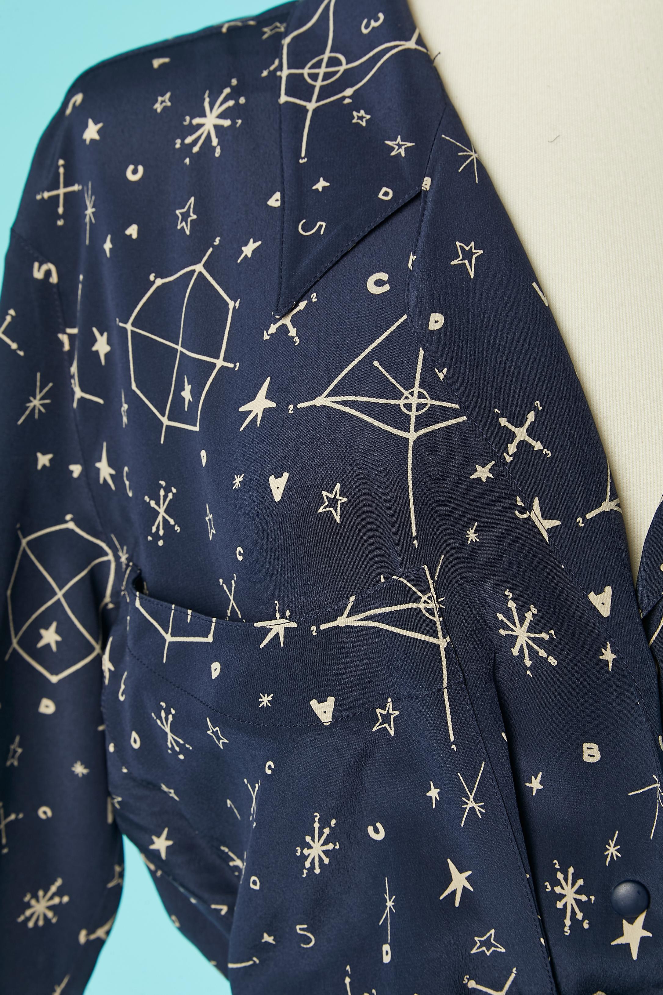 Navy silk day dress with Galaxy print. Snap in the middle front. Pockets on the bust. Double lays of fabric in the middle front on the skirt. Split on the side of the underneath lay ( lenght= 15 cm) 
SIZE 40 (Fr) M 