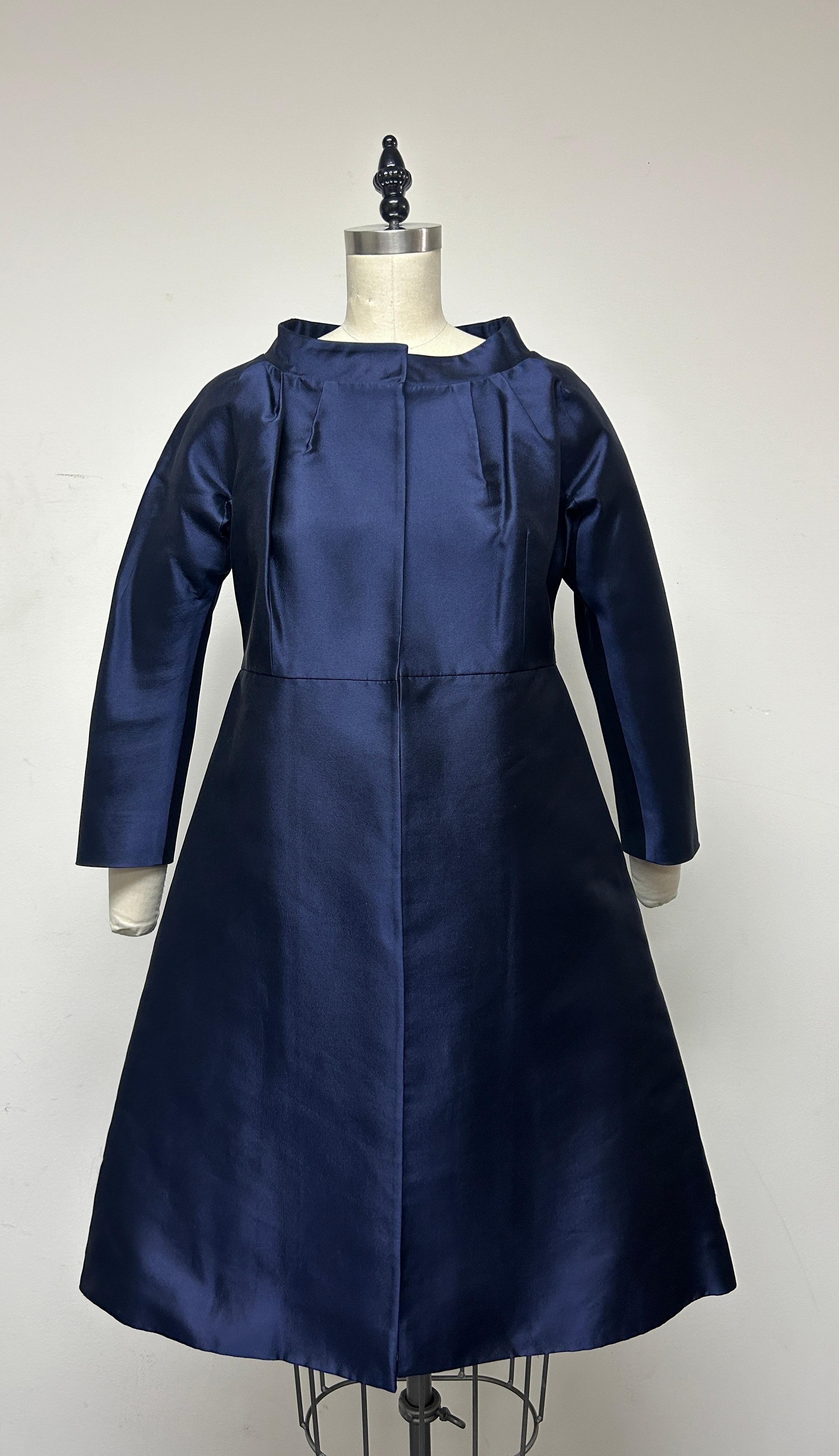 Cocktail coat the stable for decades of chic women! Crafted from exquisite Italian Taroni 100% silk Mikado in a rich, captivating iridescent navy hue, a cocktail coat that embodies timeless elegance. The 3/4 length sleeve adds a touch of elegance