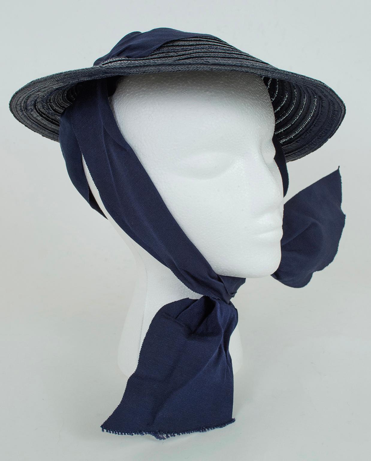 The embodiment of 1930s millinery, this petite saucer reflects the decade’s focus on small, cheerful hats perched playfully on the head. What makes it unique is its ingenious use of skillfully-darted ribbon to create a head cradle so the hat remains
