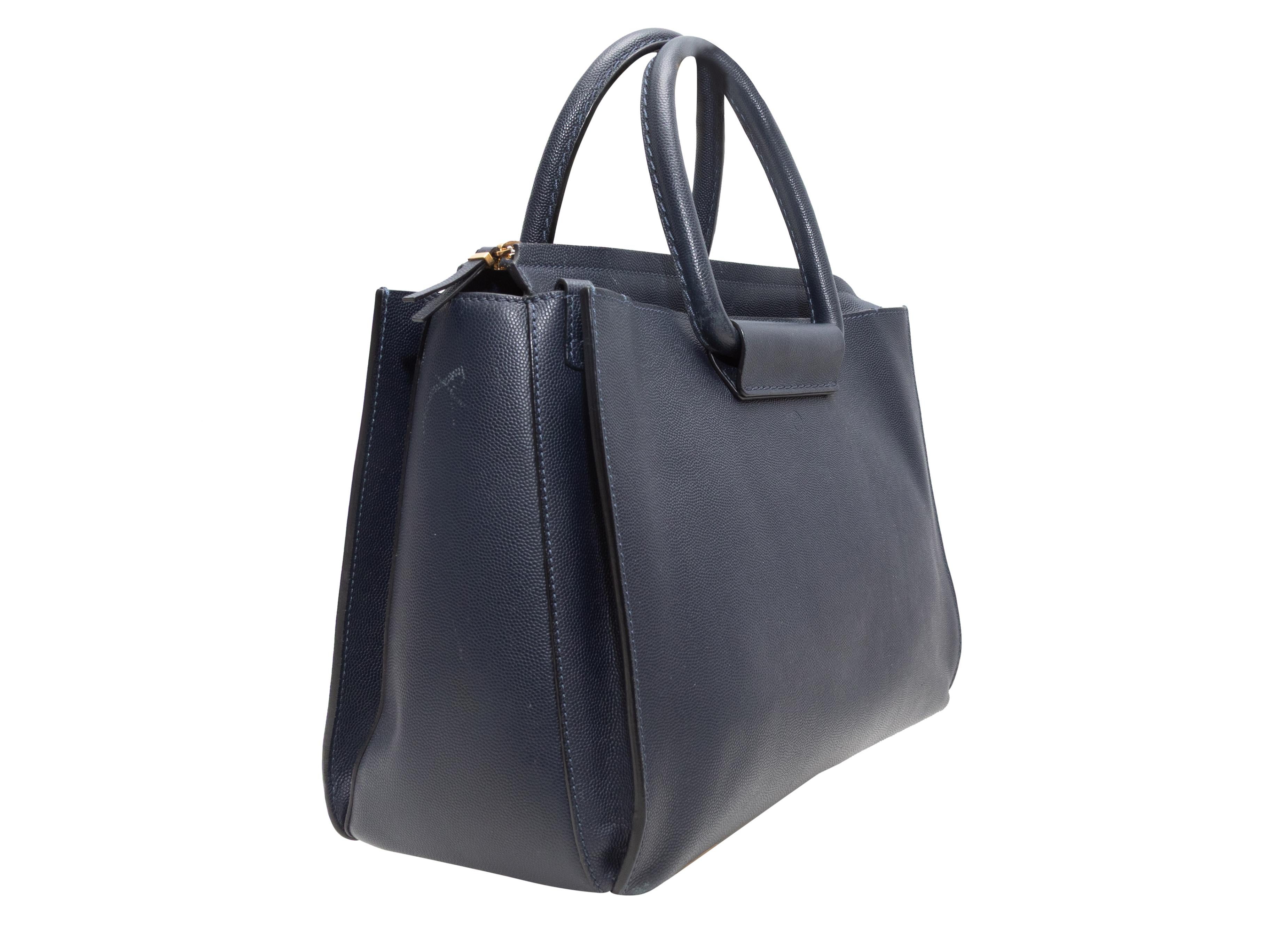 Sac fourre-tout The Row en cuir grainé, bleu marine. Ce sac fourre-tout est doté d'un corps en cuir marbré, de ferrures dorées, de deux anses roulées et d'une fermeture à glissière sur le dessus. 12.5