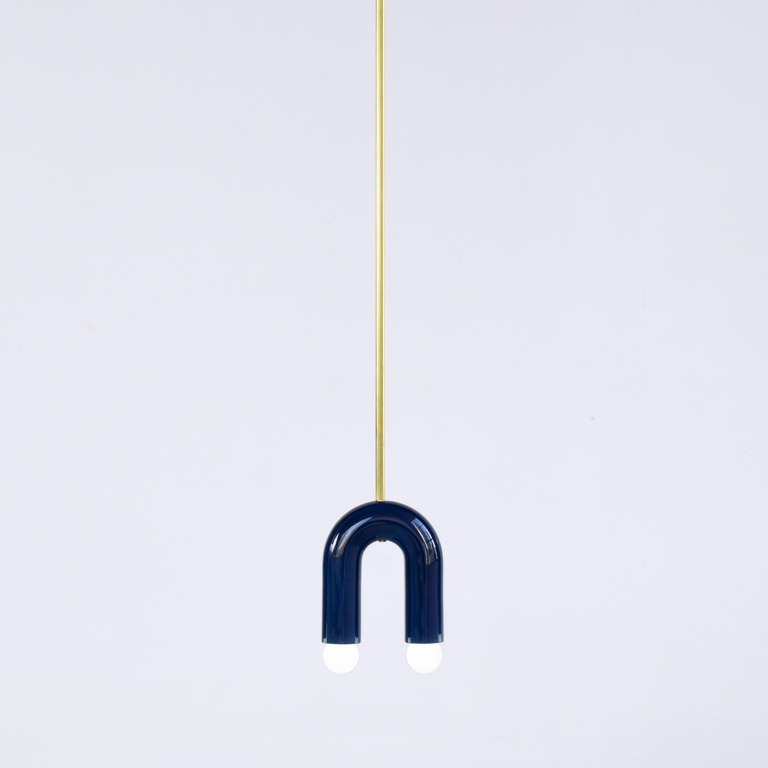 Navy TRN A1 pendant lamp by Pani Jurek
Dimensions: D 5 x W 15 x H 18 cm 
Material: ceramic and brass.
Available in other colors.
Lamps from the TRN collection hang on a metal tube, not on a cable. This allows the lamp to be mounted in a specific
