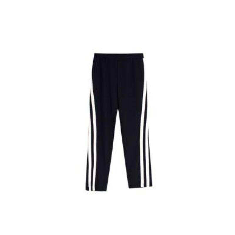 Valentino navy wool twill side stripe joggers
 
 - Straight leg joggers with an elasticated waistband, contrast side stripe and zip ankle
 - Internal drawstring 
 - Inset side pockets
 - Lightweight wool twill 
 
 Materials
 100% Virgin Wool 
 
