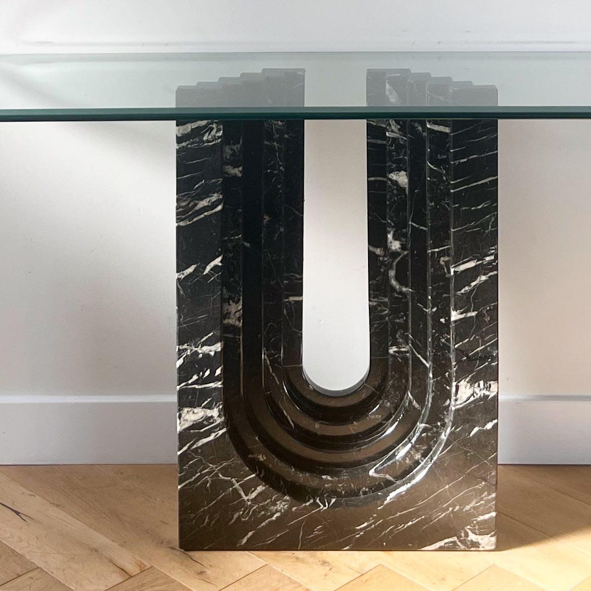 A vintage Italian “Naxos” console table by Modus Studio for Cattelan Italia, as is, 1988. Black marble, Carlo Scarpa style construction, and the thick and beveled glass top is original. The base has been repaired by a marble expert but is