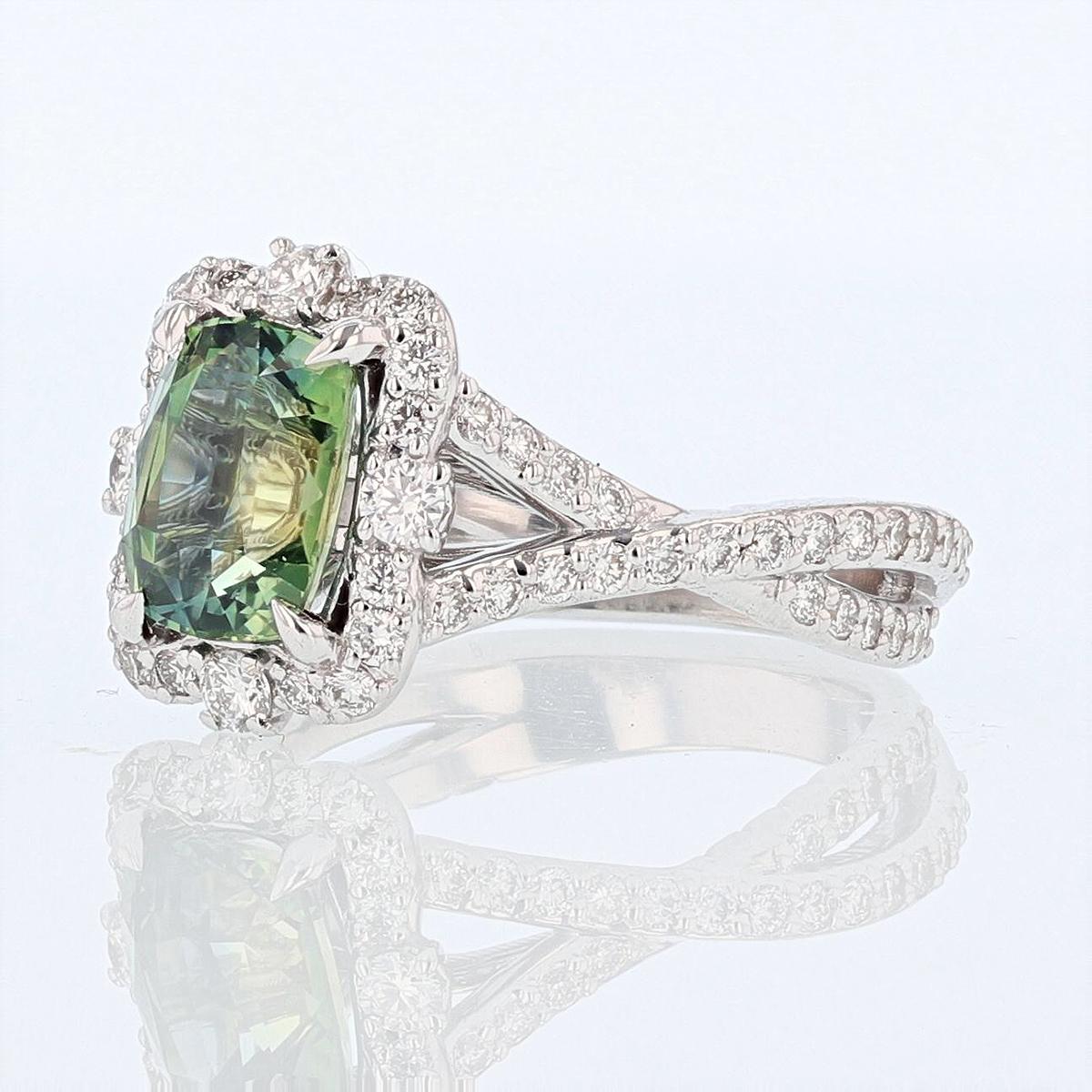 This ring is designed by Nazarelle and made in 14 karat white gold and and features a 2.51ct cushion cut green sapphire, prong set. It also features 68 round cut diamonds weighing 0.80ct, with a color grade (G) and clarity grade (VS1/VS2).
